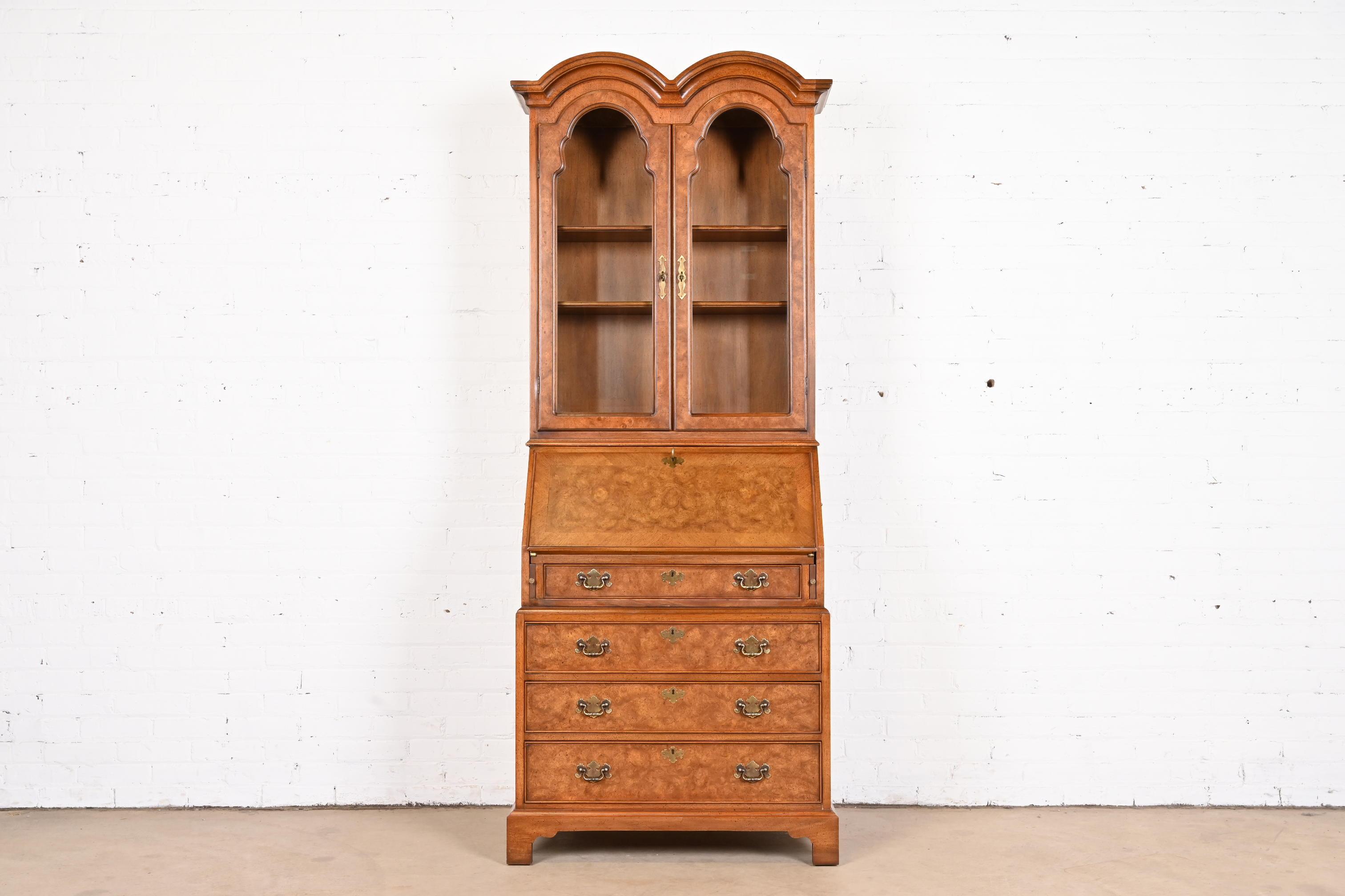 A beautiful Georgian or Queen Anne style bureau with drop front secretary desk and bookcase hutch top

By John Stuart

USA, circa 1960s

Gorgeous burled walnut, with leather writing surface, original brass hardware, and glass front