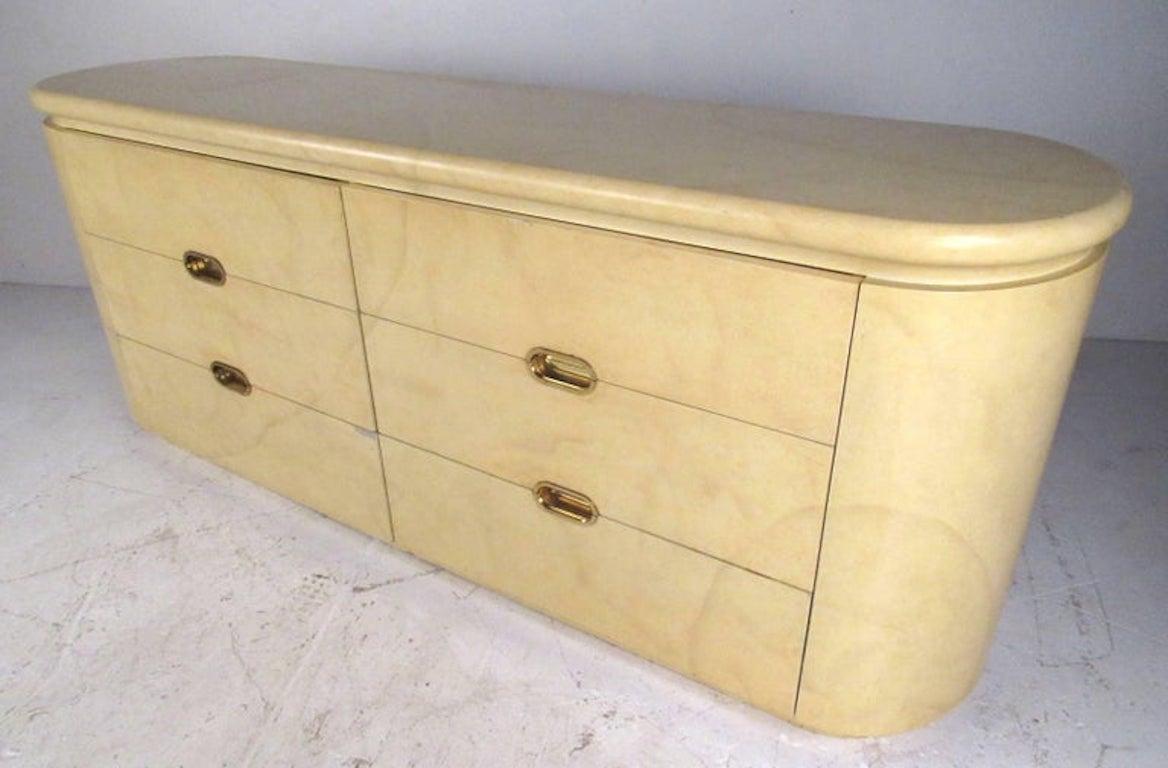 Vintage John Stuart six-drawer dresser with brass pulls, rounded sides and faux goatskin finish. Please confirm item location (NY or NJ) with dealer.
 