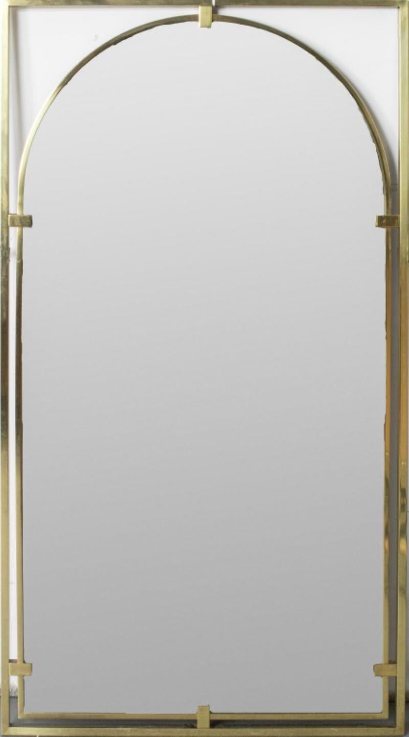 John Stuart Hollywood Regency style brass mirror, the arched plate supported within a rectangular frame. 44.5” H x 24.5” W x 1” D.