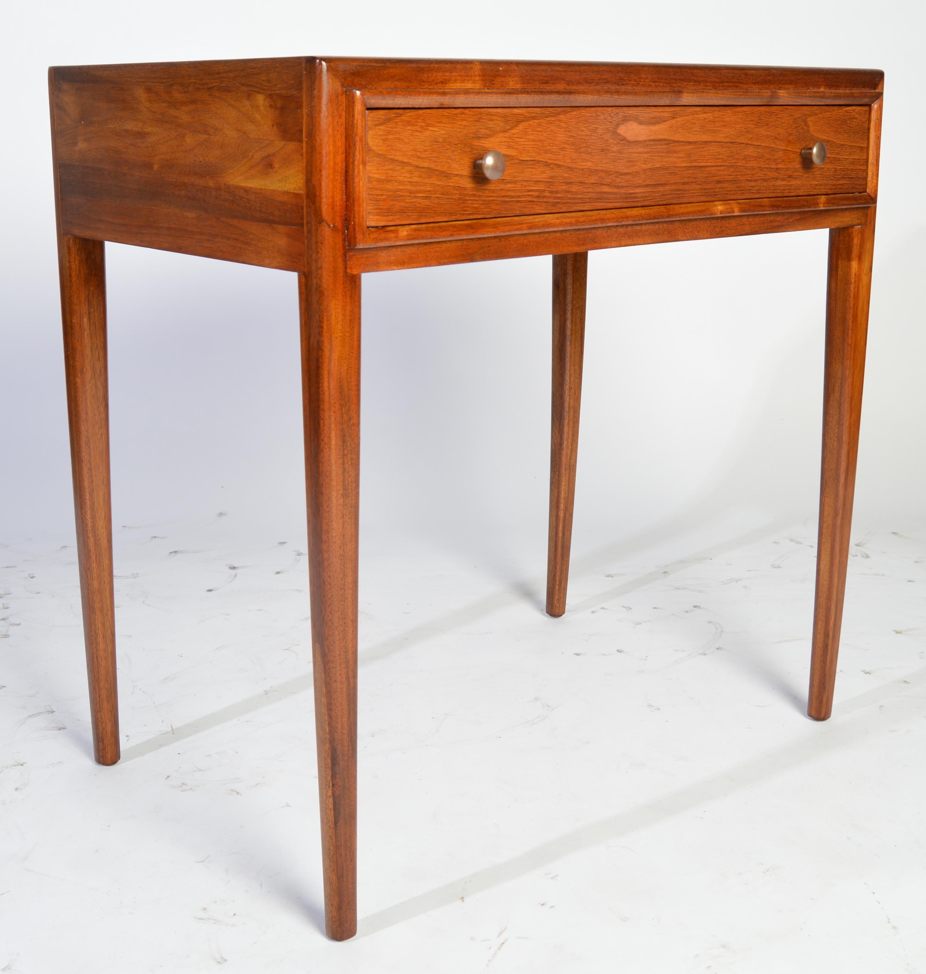 A beautiful, tall mahogany side table with single drawer having brass pulls manufactured by John Stuart for their Janus collection. 
Outstanding overall condition inside and out.