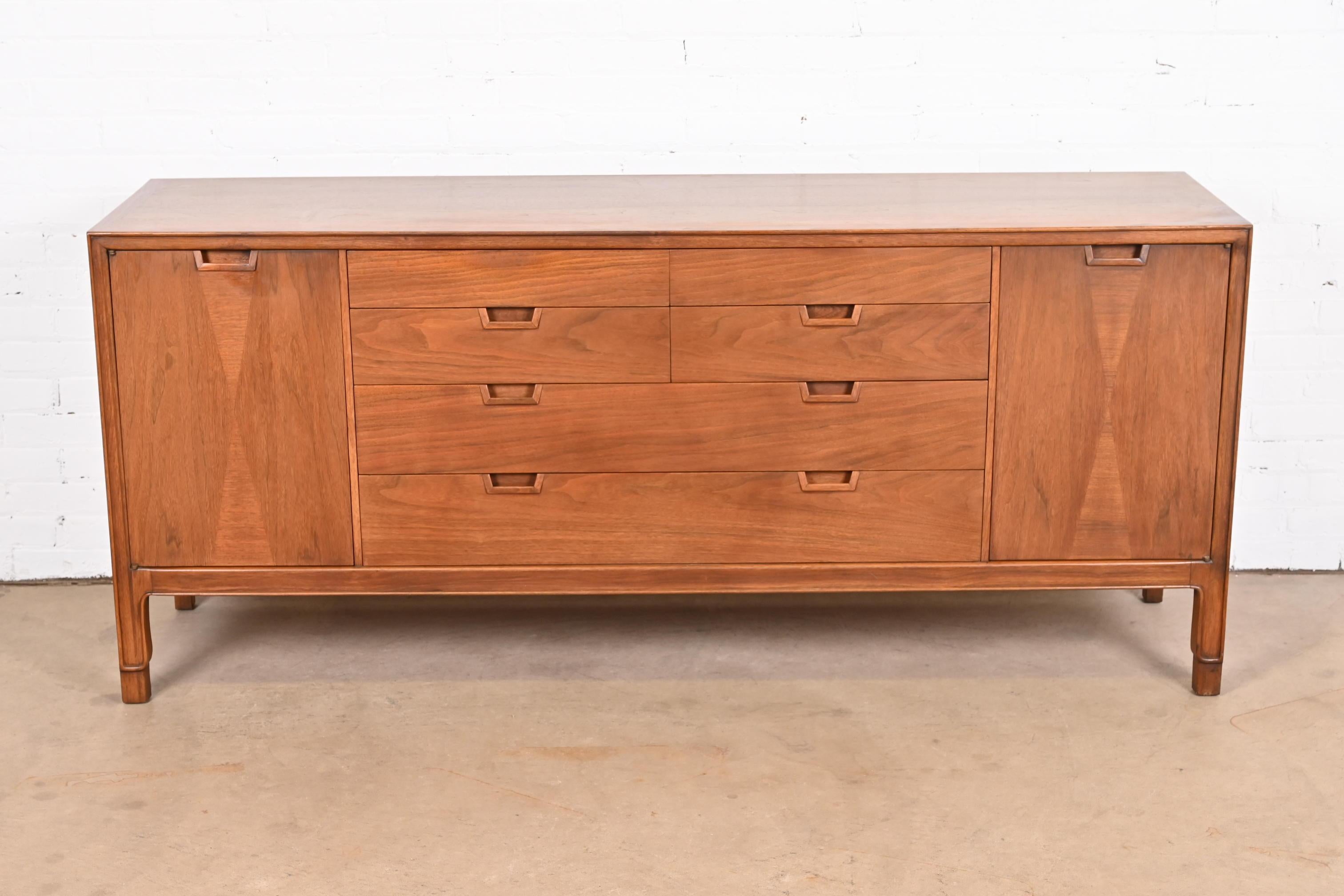 An exceptional Mid-Century Modern sculpted walnut 14-drawer long dresser or credenza

By John Stuart for Mount Airy 
