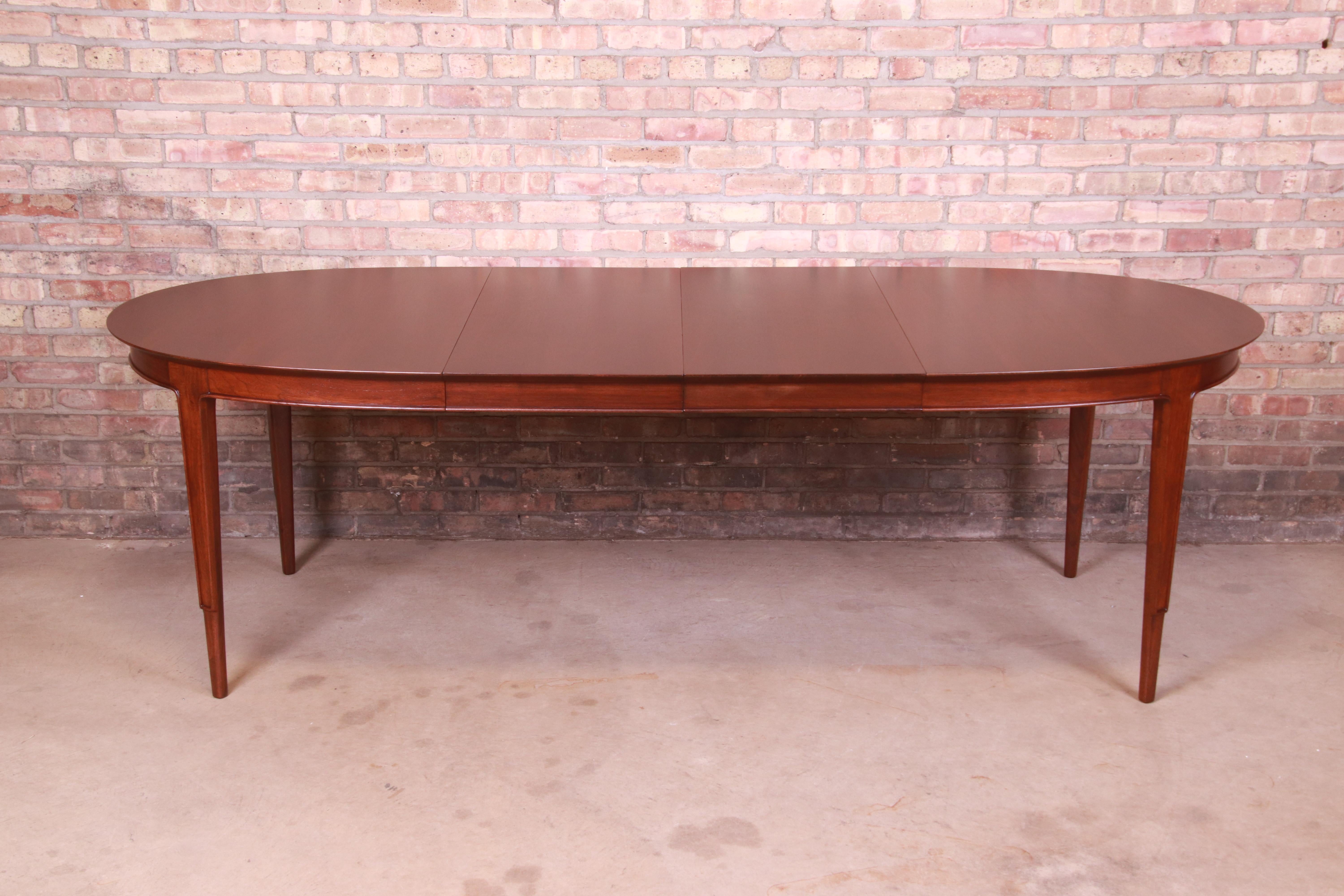 An exceptional Mid-Century Modern sculpted walnut oval extension dining table

By John Stuart, 