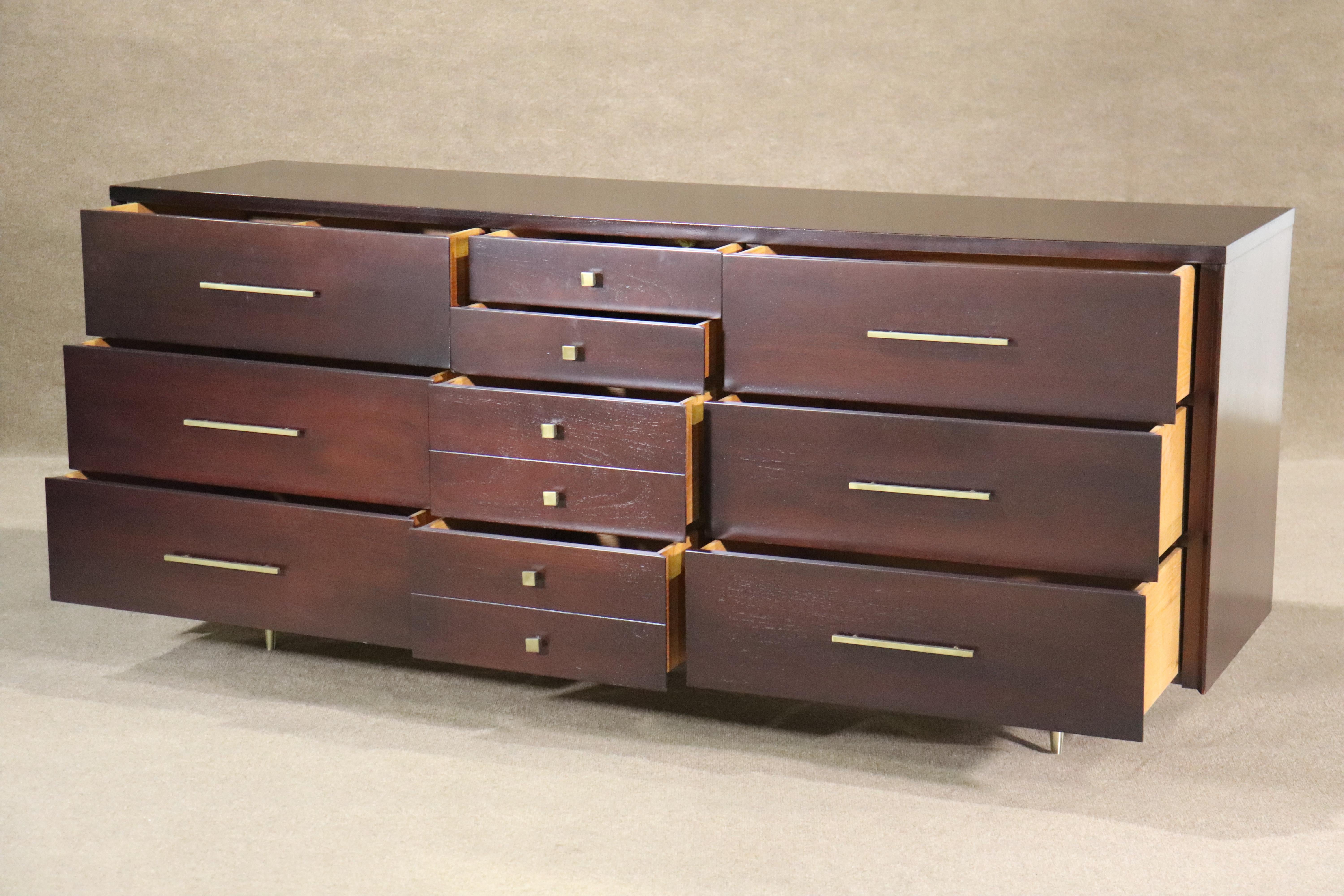 Long six foot dresser for John Stuart Inc. Deep mahogany wood with accenting brass hardware.  Ten total drawers for bedroom storage.
Please confirm location NY or NJ