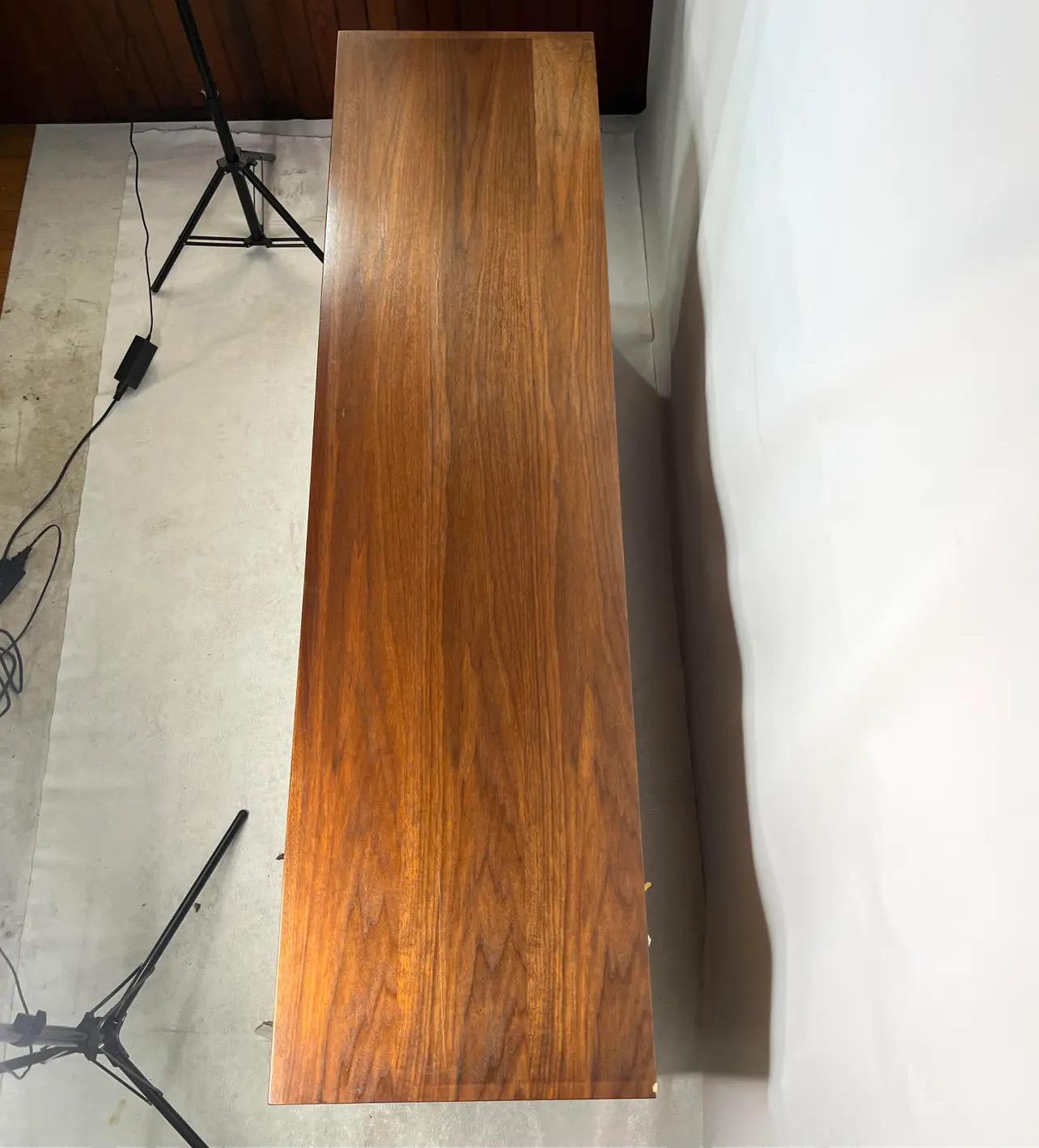 For sale is this gorgeous walnut credenza made by mount airy furniture company designed by John Stuart.