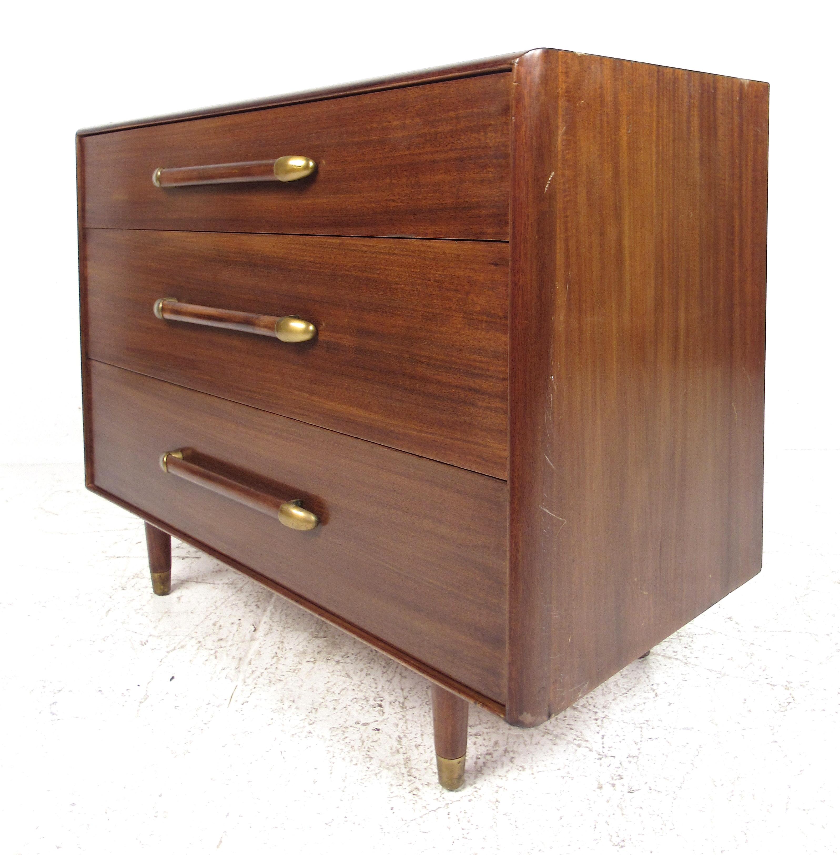 Three drawer dresser with book-matched walnut front and tapered brass-capped legs by John Stuart Inc. Please confirm item location (NY or NJ) with dealer.

 