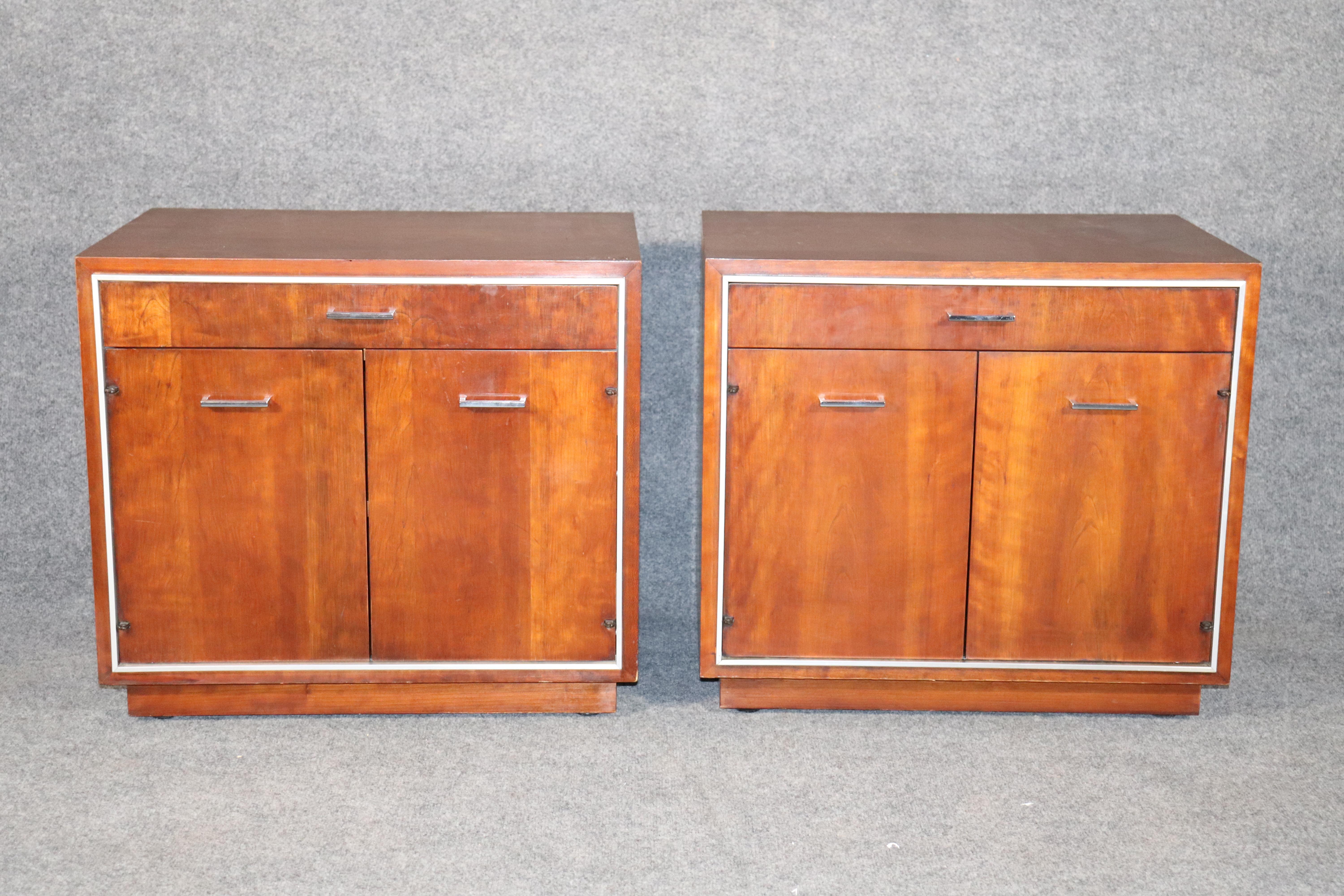 Pair of Mid-Century Modern end tables by John Stuart. Walnut grain with chrome trimming.
Please confirm location.