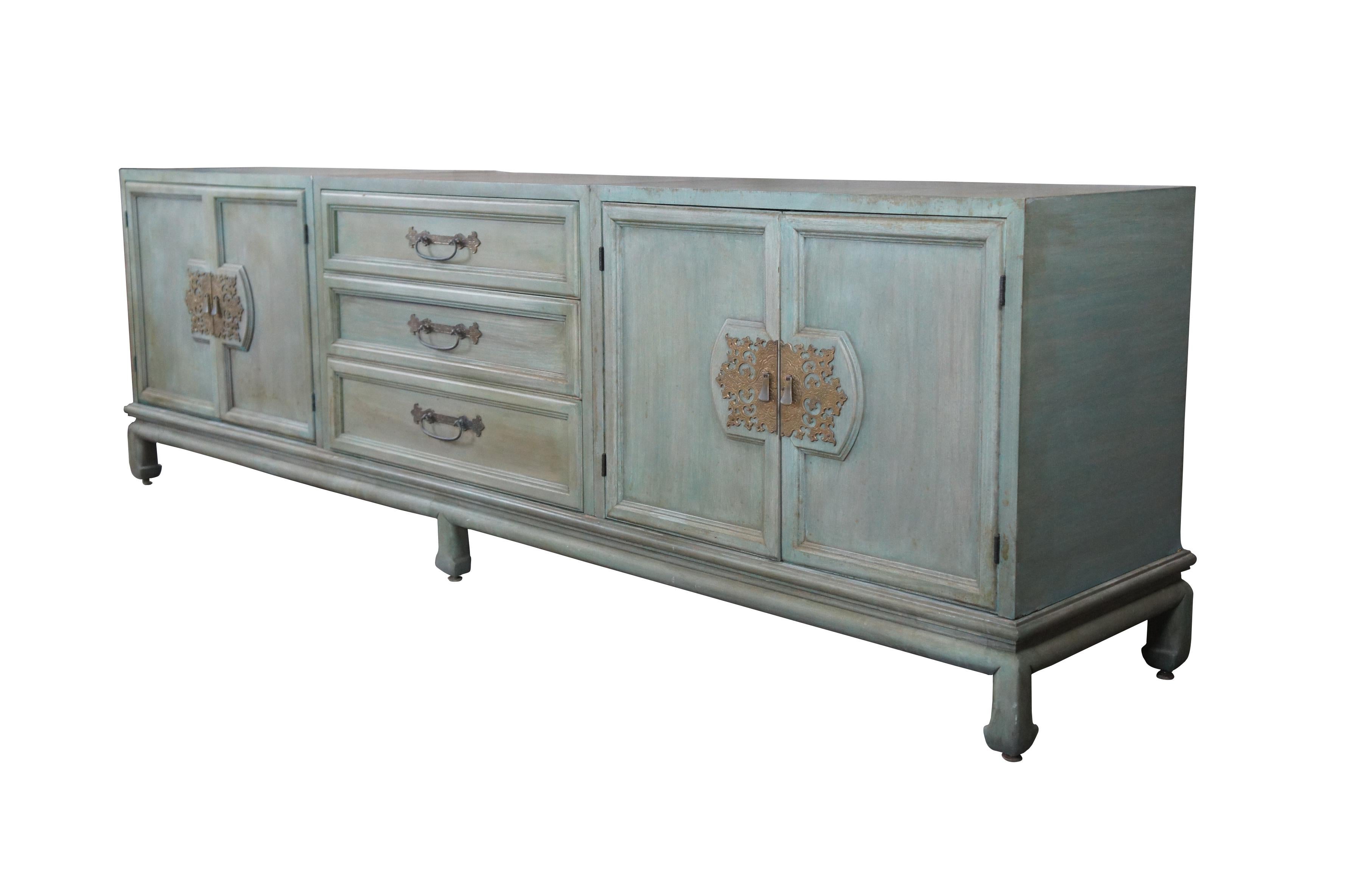 A rare and impressive vintage John Stuart Mid-Century Modern chinoiserie 3 piece credenza, dresser or media cabinet. A rectangular form made from mahogany with a green painted finish and brass hardware. Features a central chest of three dovetailed