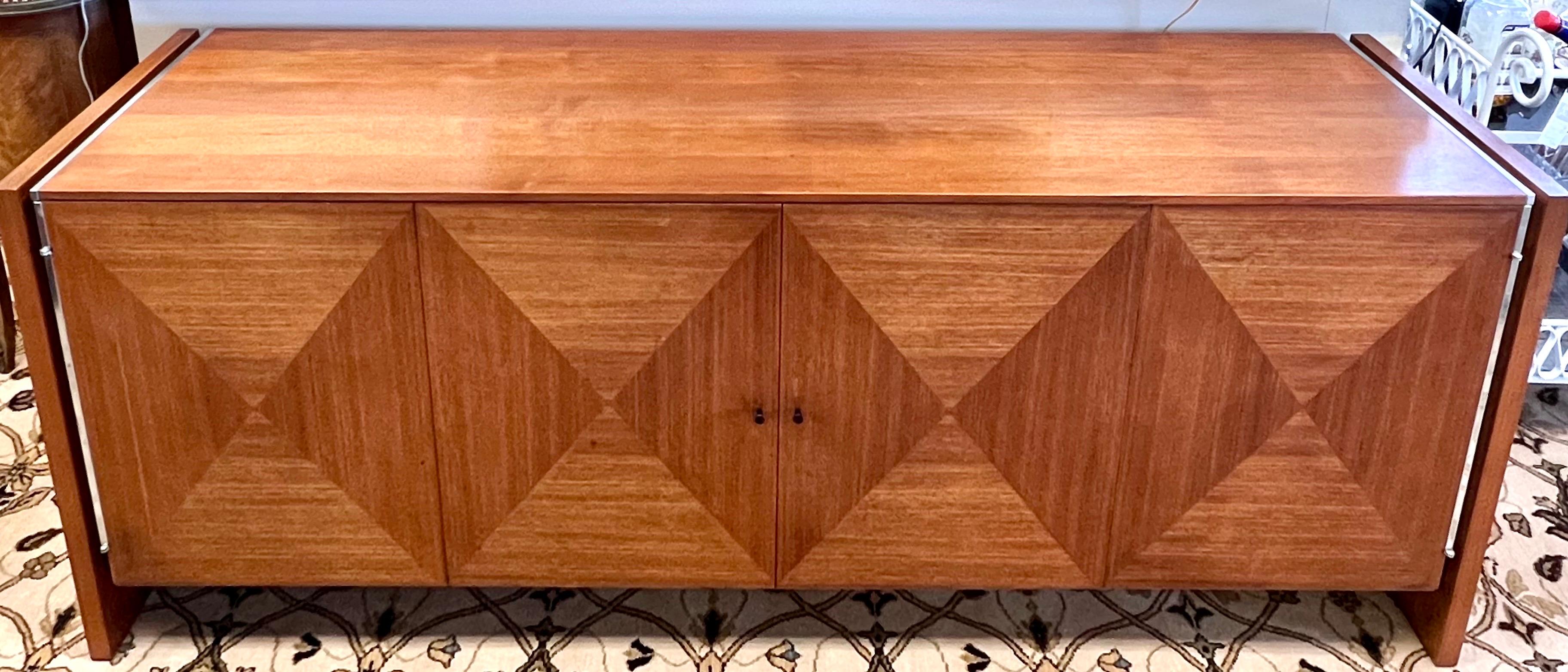 Luxurious and iconic John Stuart midcentury long walnut credenza/sideboard/buffet/server that features the coveted diamond pattern on front doors. Two center door open tambour style to show ample storage. Both sides of cabinet have chrome accents