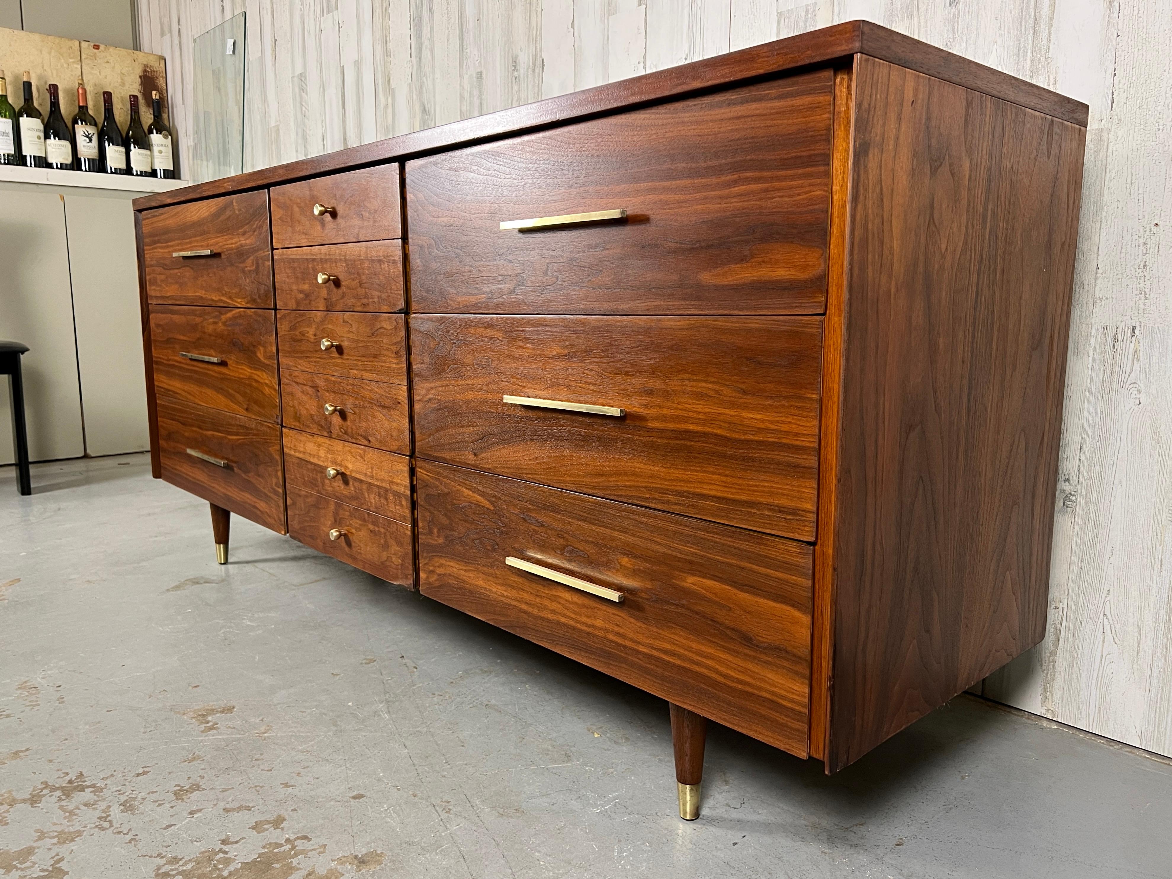 Beautiful walnut dresser with solid brass drawer pulls by John Stuart with six large drawers and two smaller, then two even smaller on center top.
