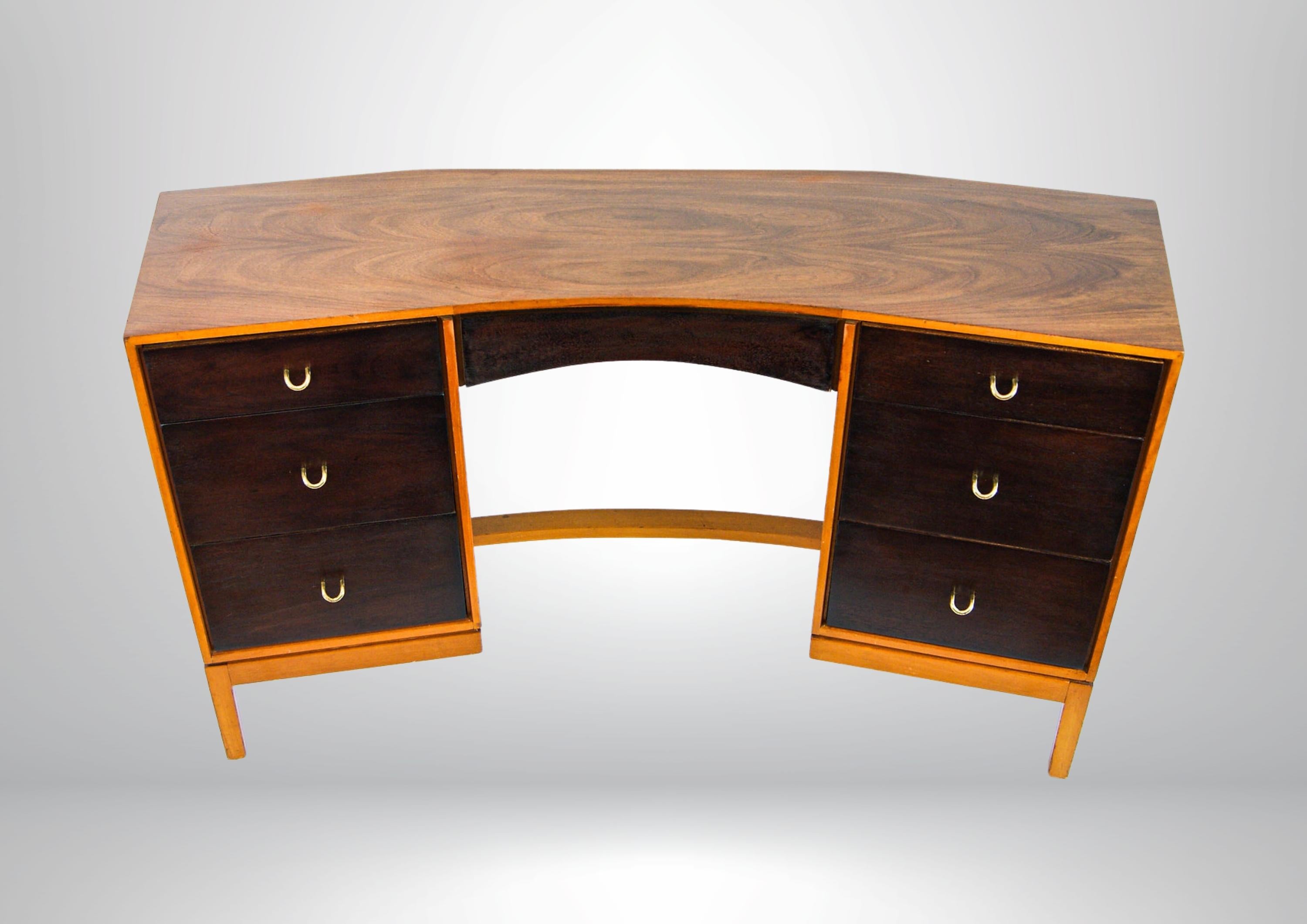 Mid-century British made desk by John & Sylvia Reid for Stag furniture.
Walnut veneer top and sides, with a darker rosewood finish to the front.
Stands on double pedestals with a 6 drawer compartments.
The drawers have solid brass curved handles,