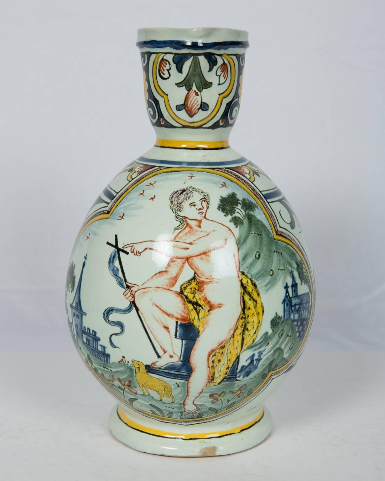 We are pleased to offer this French faience polychrome pitcher. In the center rests St. John the Baptist. On the other side of the pitcher is inscribed: 