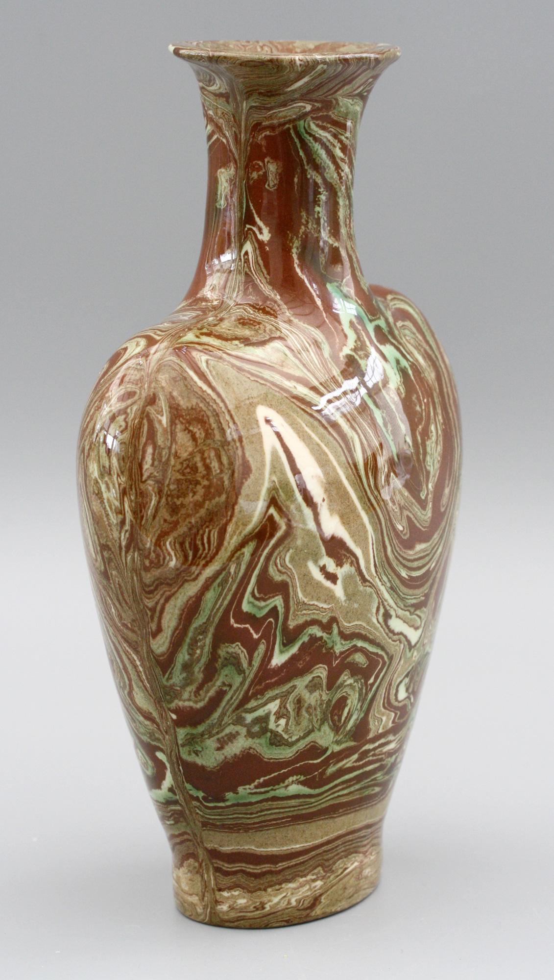 A stylish and unusual heart shaped brown marbled agate pottery vase by John Thomas Morton and made at his Filey workshop in Yorkshire, circa 1933. This stylish pottery vase is made in red clay with marbled swirls in green, cream and light brown