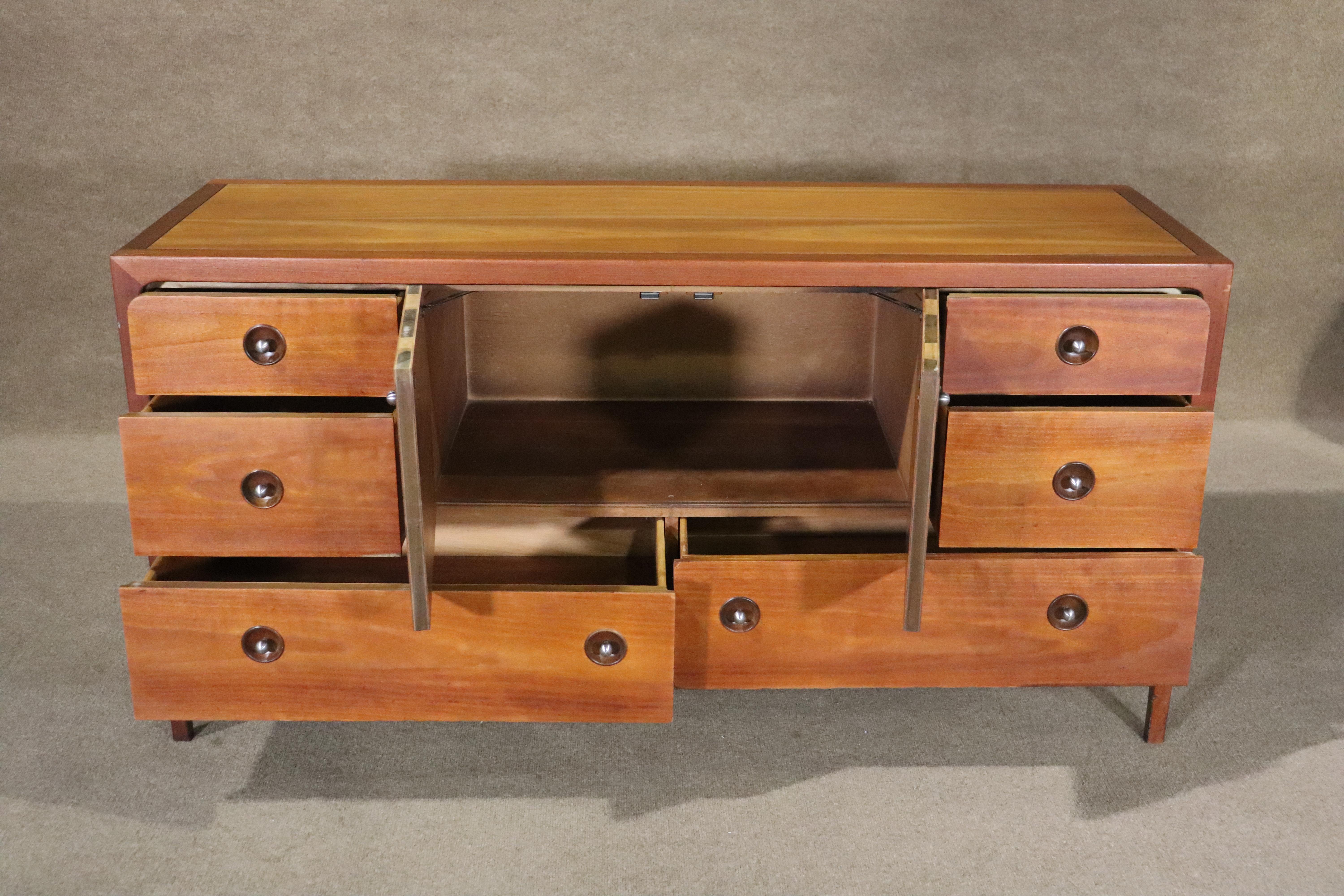Great mid-century design by John Van Koert with luxurious mahogany, blended with wild-grained cherry wood. Inset hardware, rounded lines and tapered legs. Six drawers and center cabinet storage.
Please confirm location NY or NJ