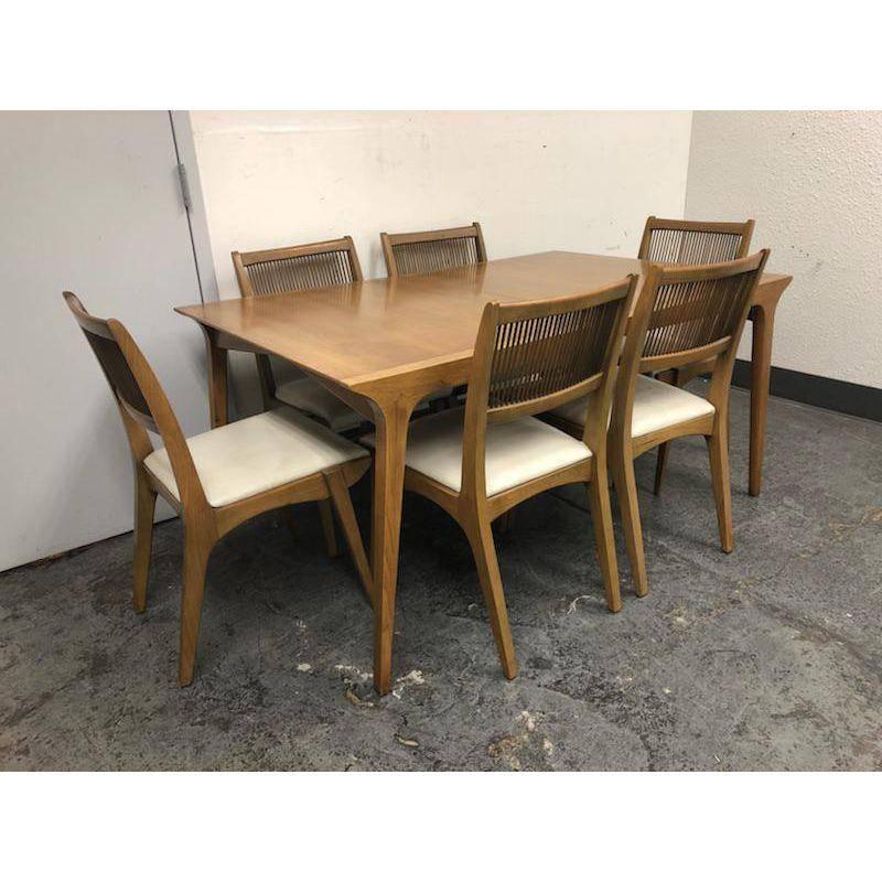 A midcentury table set designed by John Van Koert for Drexel Profile Series. This fabulous set consist of six side chairs, upholstered in a ivory leather. Has aged gracefully, minor fading, one leather has noticeable distressing. You can easily