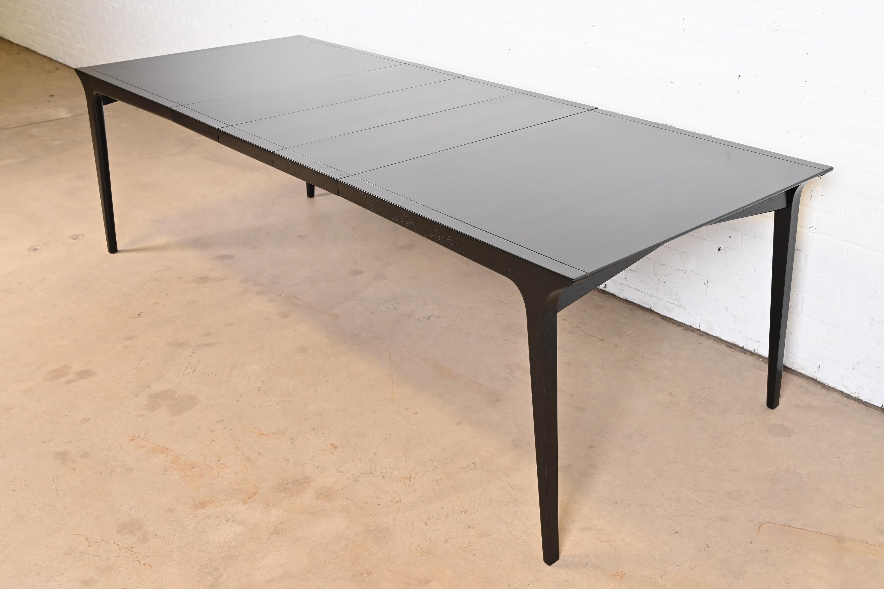 An exceptional Mid-Century Modern black lacquered walnut extension dining table

By John Van Koert for Drexel, 