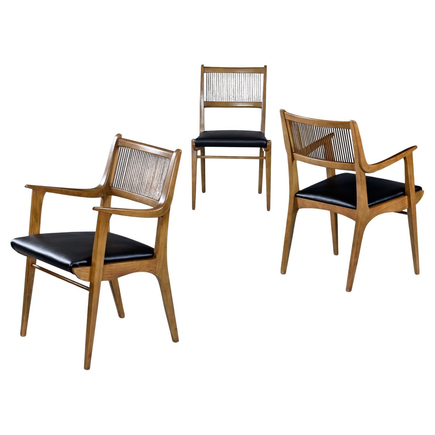 Drexel Profile walnut and pecan K60 Arm Chairs and Side Chairs, circa 1950s.  Built like tanks, this large set of eight spindle back beauties have been restored to lovely condition.  New faux leather Scalamandre vinyl seats are the perfect