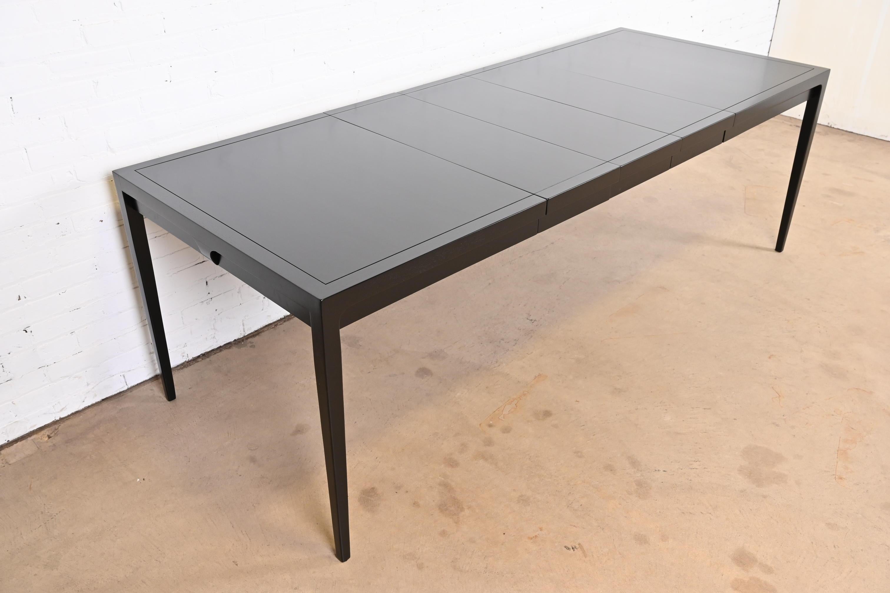 A sleek and stylish Mid-Century Modern black lacquered extension dining table

By John Van Koert for Drexel, 