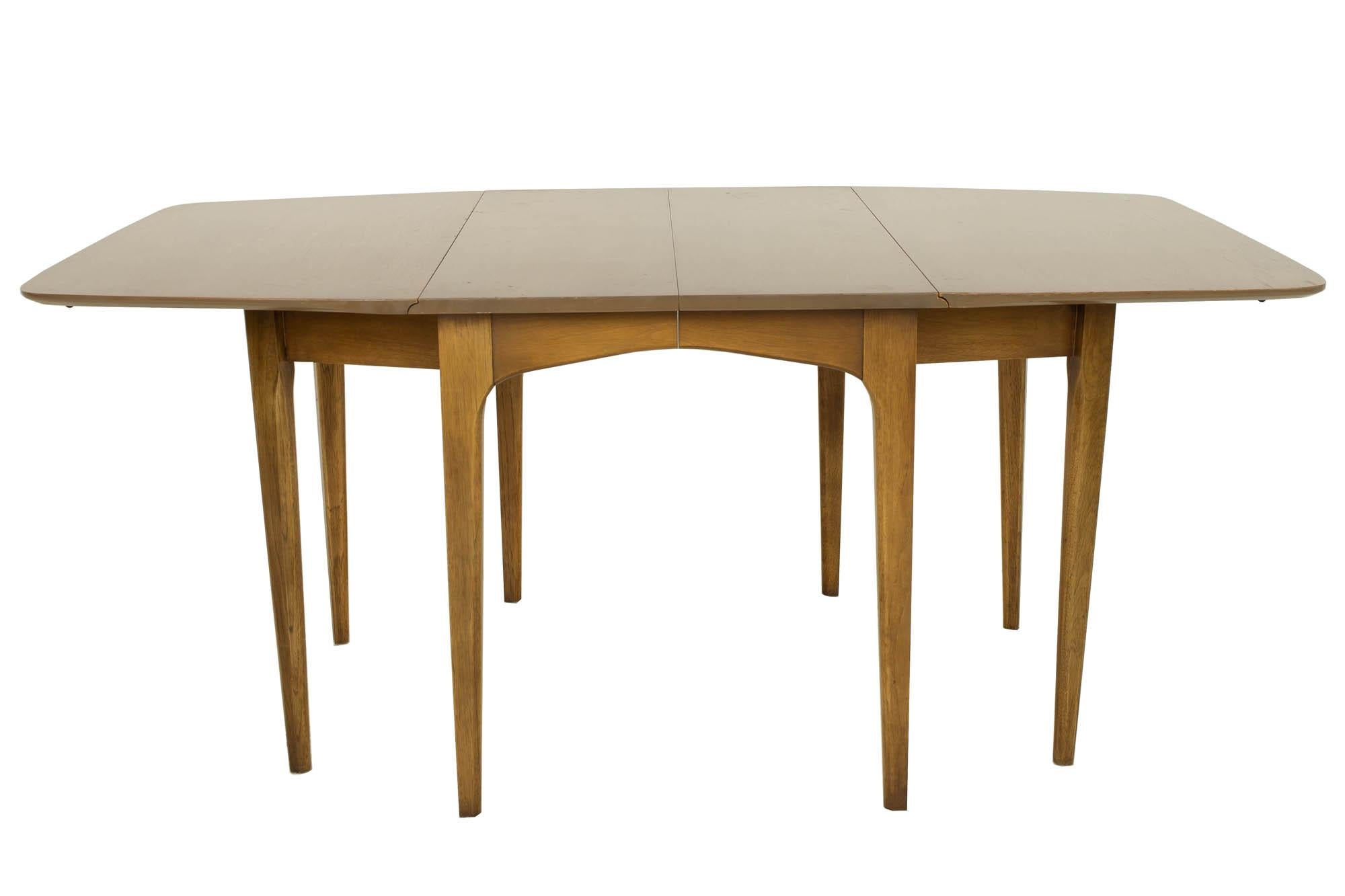 John Van Koert for Drexel mid century walnut drop leaf dining table

This table measures: 71 wide x 42 deep x 30 inches high, each table leaf measures 12 wide making the table 107 inches wide, with a chair clearance of 26.25 inches

?All pieces