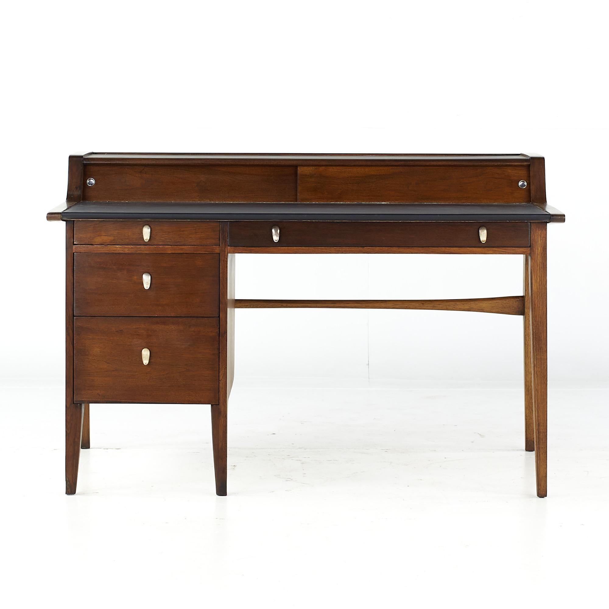 John Van Koert for Drexel Profile mid century leather top walnut desk

This desk measures: 53.75 wide x 33 deep x 35.5 high, with a chair clearance of 25.5 inches

All pieces of furniture can be had in what we call restored vintage condition.