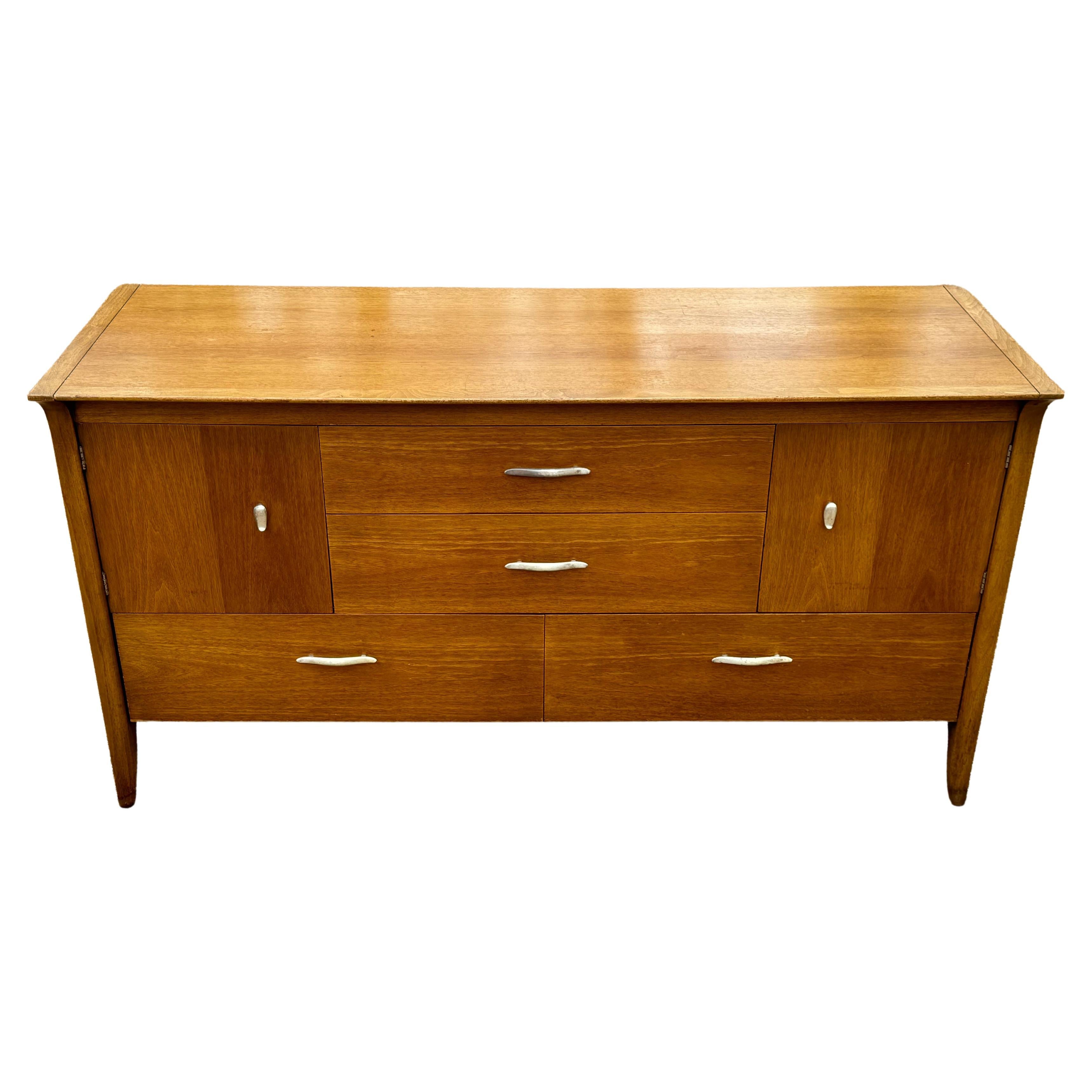 John Van Koert for Drexel designed sculptural Sideboard, buffet or Credenza designed as part of the classic Profile series. This walnut veneered sideboard has same sleek lines as the dining table, having unique silver plated hardware, two center