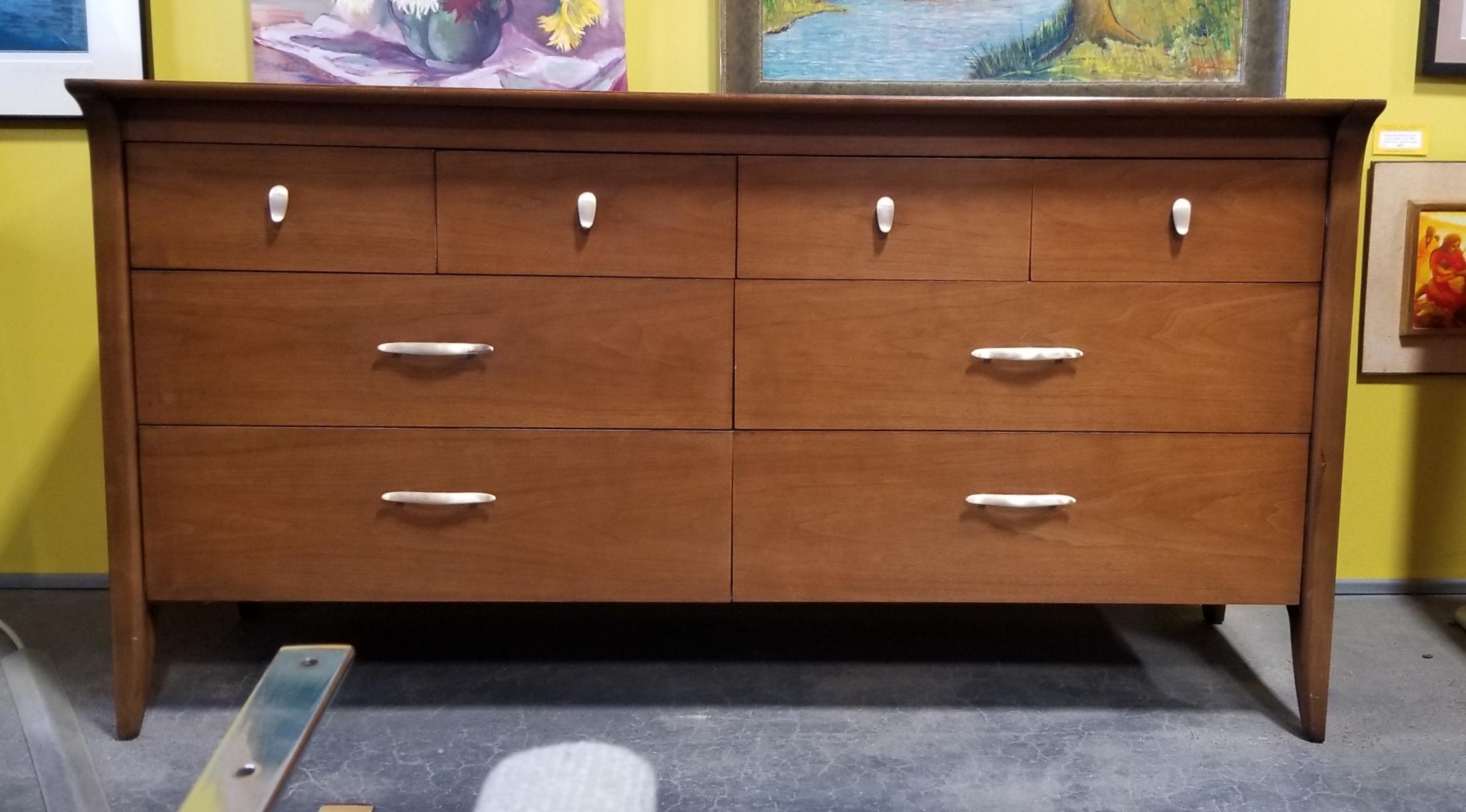 Quality craftsmanship and materials in this Mid-Century Modern low dresser designed by John Van Koert for Drexel Furniture. Ample storage featuring 8 drawers. All wood construction solid oak secondary woods and dovetail detail. Very good original