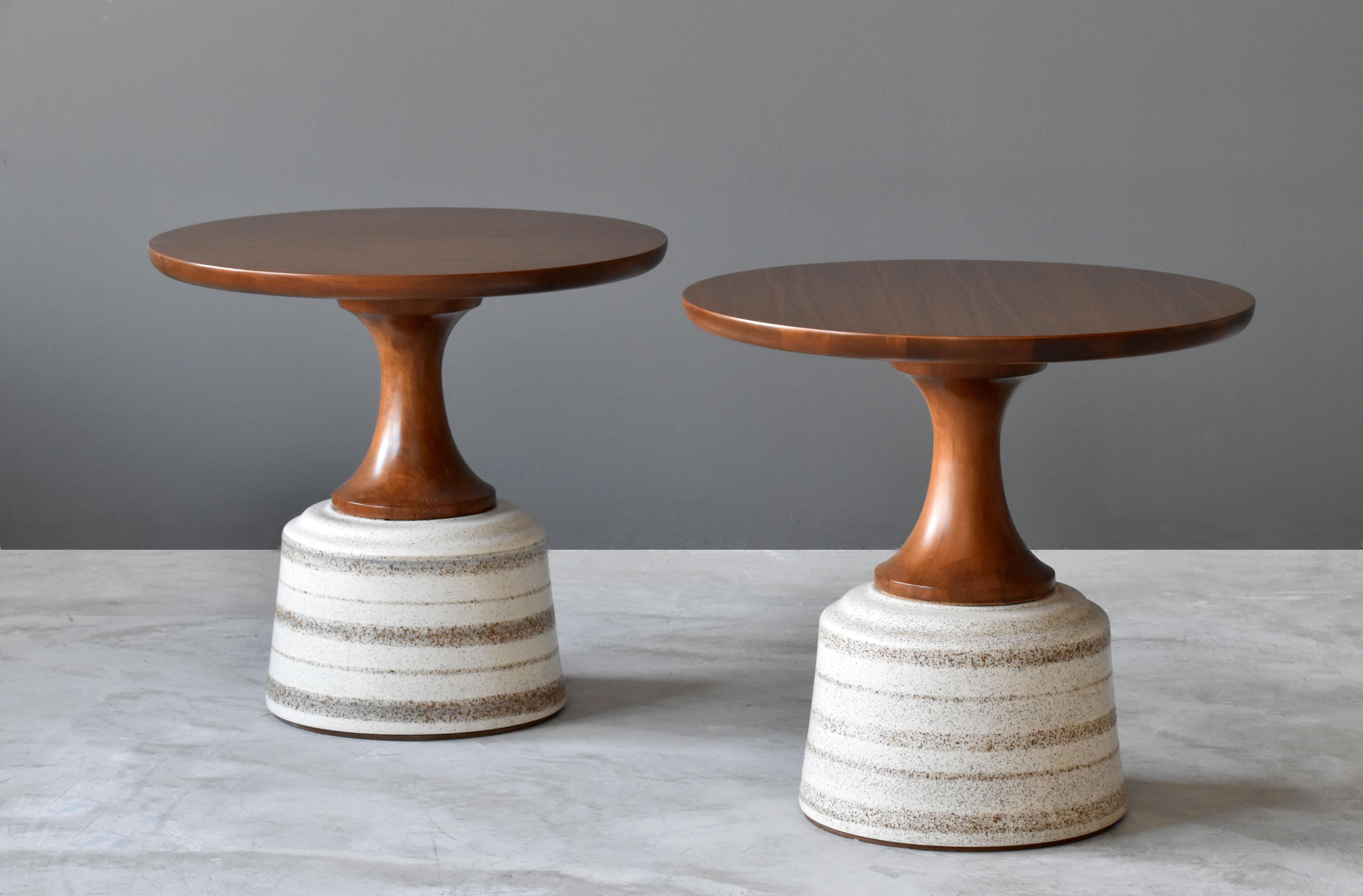 A pair of side table or occasional tables, designed by John Van Koert and produced by Drexel Furniture Company, North Carolina, America. 

Finely carved cherrywood tops are mounted atop the glazed ceramic bases. 


 