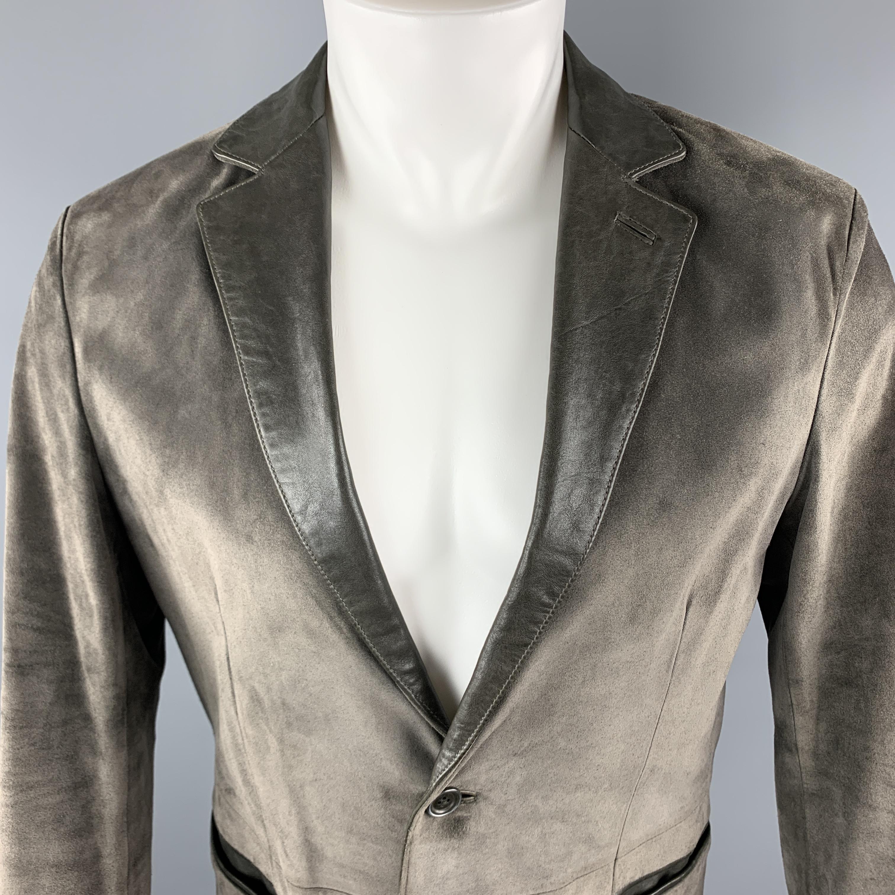 JOHN VARVATOS JACKET comes in a slate suede material, featuring a notch lapel, a leather trim, two buttons at closure, single breasted, slit pockets, functional buttons at cuffs, and a single vent at back. 

Excellent Pre-Owned Condition.
Marked: IT