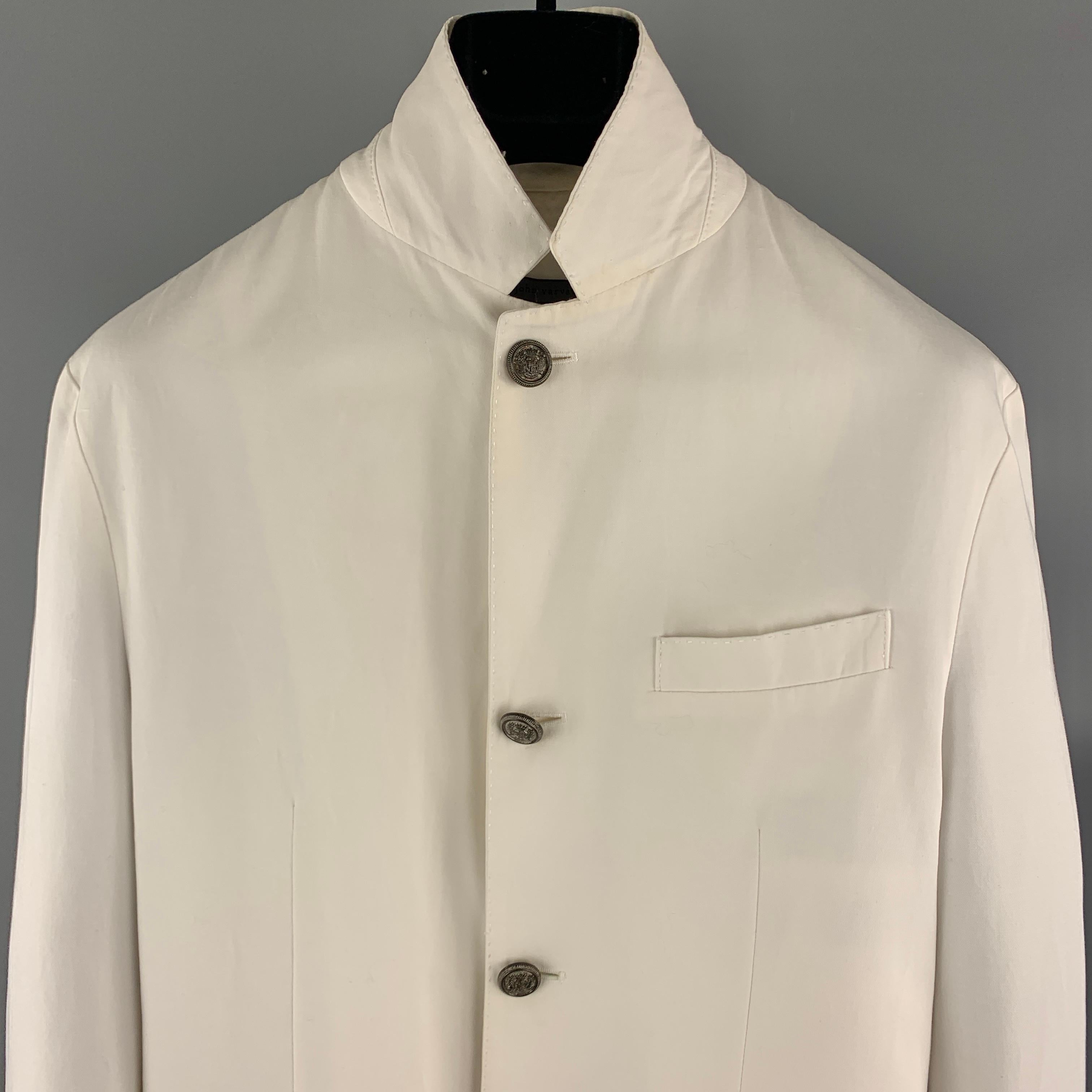 JOHN VARVATOS Jacket comes in a white cotton / linen material, featuring embossed silver metal four buttons at closure, single breasted, slit and flap pockets, functional buttons at cuffs, a single vent at back, unlined. Minor wear at inner collar.