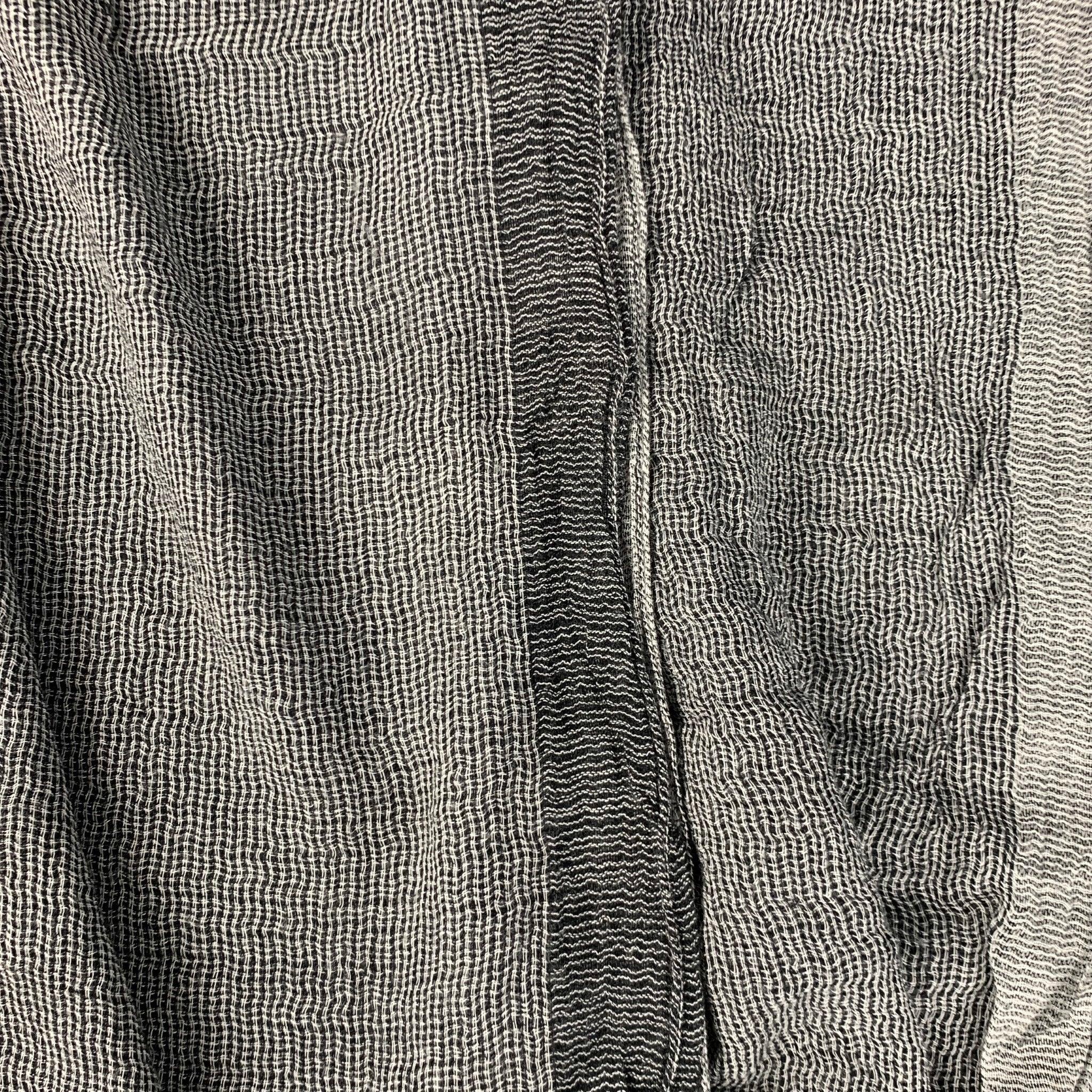 JOHN VARVATOS scarf
in a soft black and white viscose modal blend scarf featuring raw edge and a monochromatic color block style. Made in Italy. Very Good Pre-Owned Condition. Minor signs of wear. 

Measurements: 
  70 inches  x 12.5 inches 
  
  
