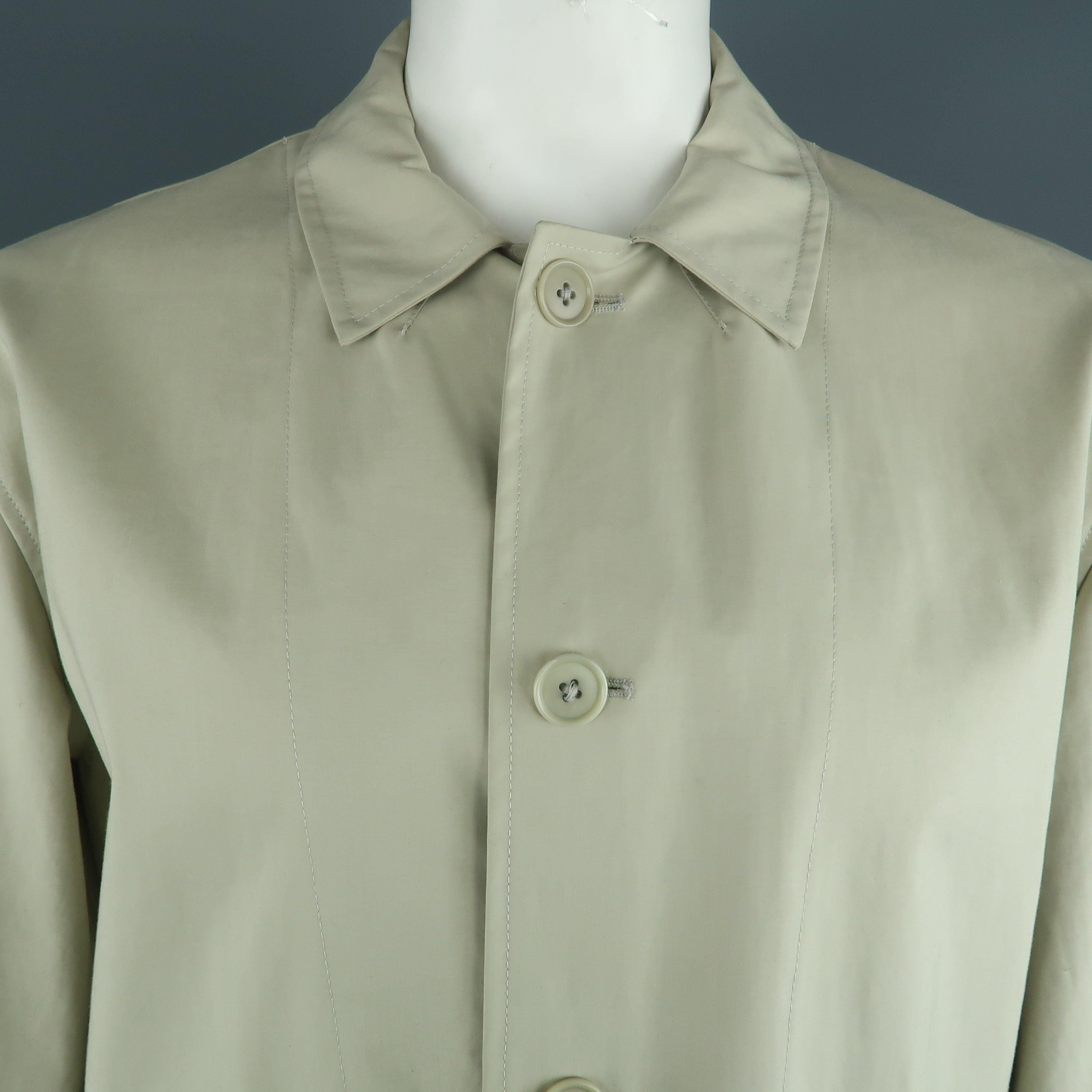 JOHN VARVATOS coat comes in a khaki cotton featuring a belted style and flap pockets. Made in Italy.Very Good Pre-Owned Condition. 

Marked:   XL 

Measurements: 
 
Shoulder: 20.5 inches  Chest: 48 inches  Sleeve: 25 inches  Length: 30 inches   
  

