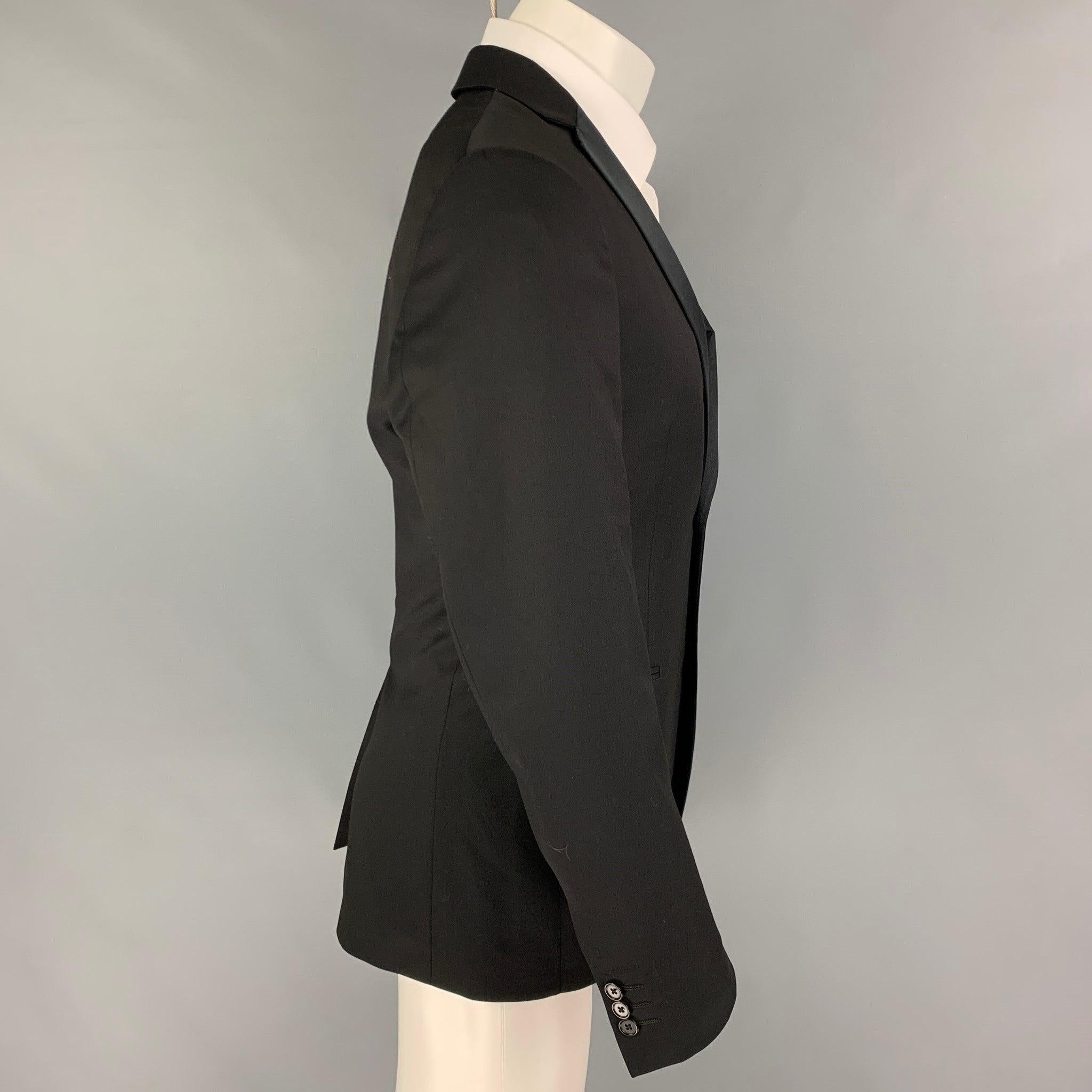 JOHN VARVATOS sport coat comes in a black wool with a full liner featuring a notch lapel, slit pockets, single back vent, and a double button closure. Made in Italy.
Very Good
Pre-Owned Condition. 

Marked:   46 

Measurements: 
 
Shoulder: 17