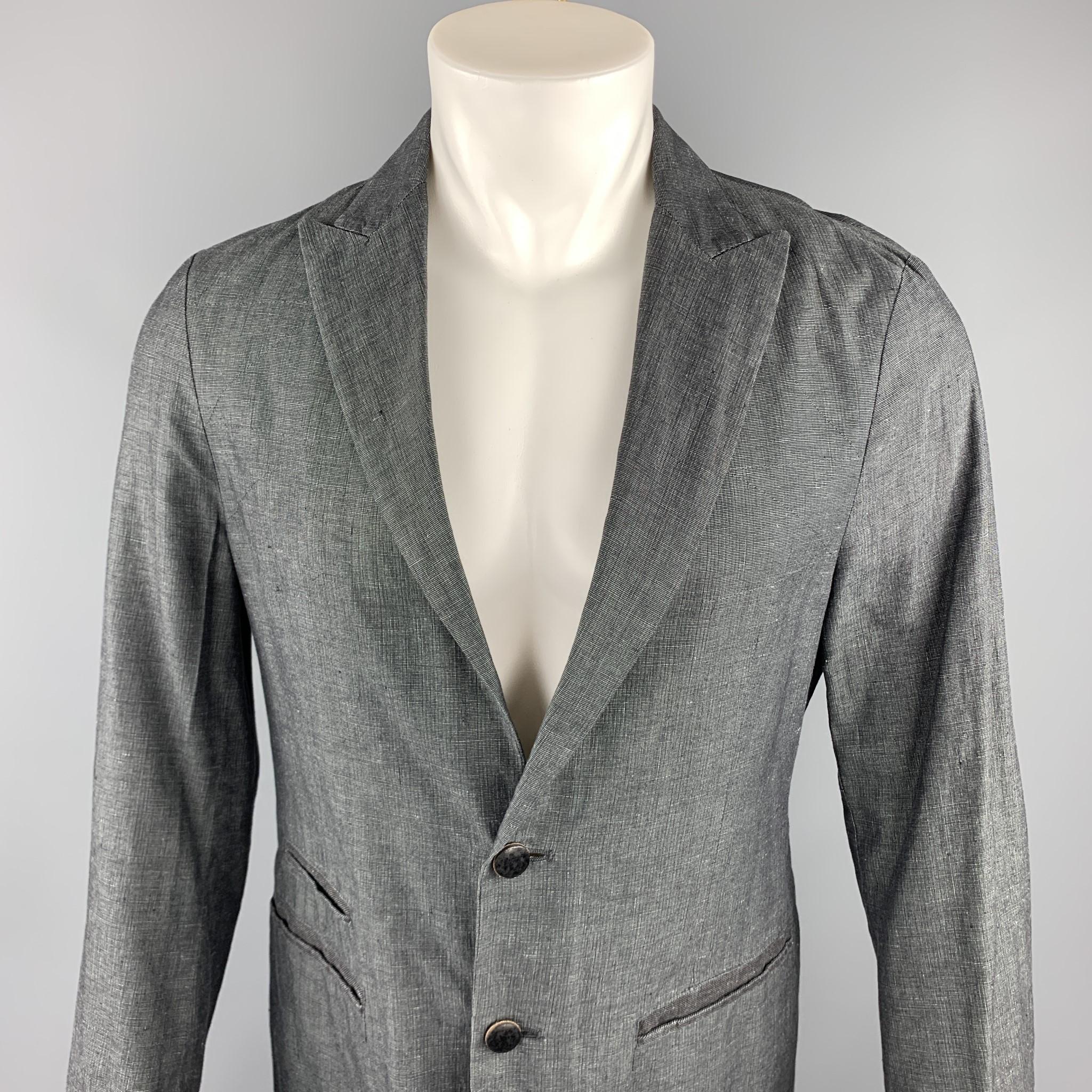 JOHN VARVATOS sport coat comes in a dark gray heather linen / cotton featuring a peak lapel style, stitching details, slit pockets, and and a two button closure. Made in Italy.

Excellent Pre-Owned Condition.
Marked: IT 46

Measurements:

Shoulder: