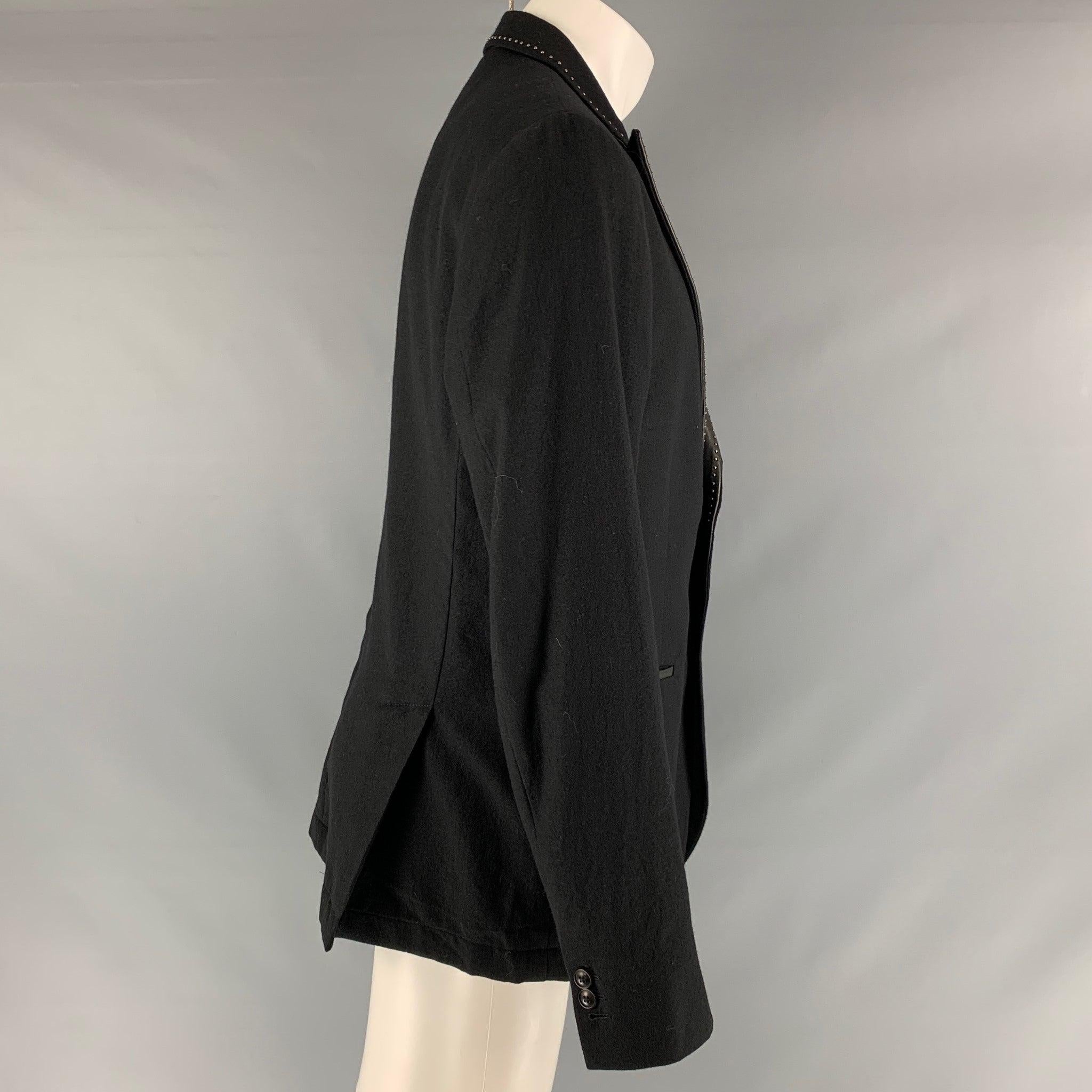 JOHN VARVATOS sport coat comes in a black wool woven material with a half liner featuring a peak lapel, studded lapel details, slit pockets, and a single button closure. Excellent Pre-Owned Condition. 

Marked:   54 

Measurements: 
 
Shoulder: 18.5