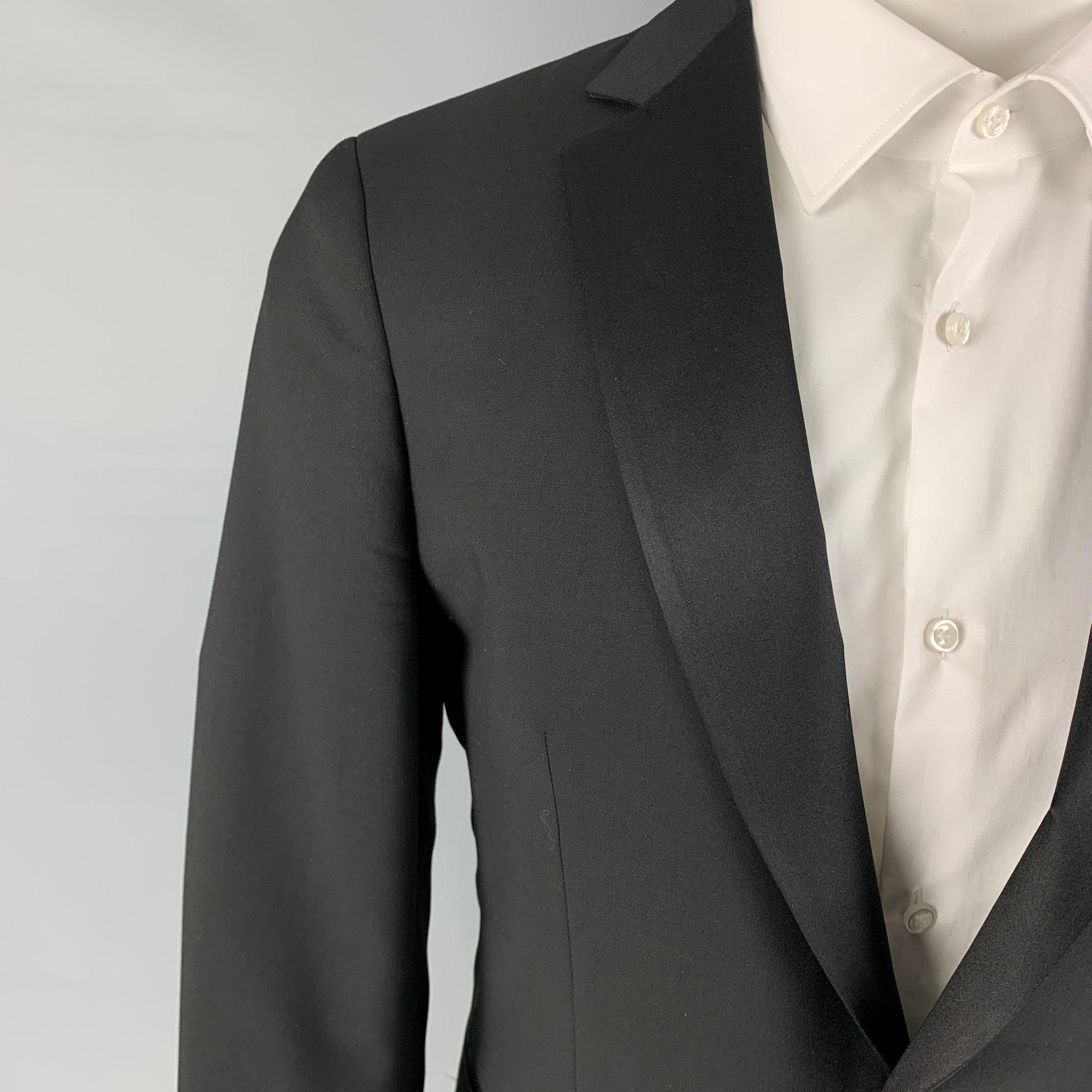 JOHN VARVATOS tuxedo sport coat comes in a black wool with a full liner featuring a notch lapel, slit pockets, single back vent, and a single button closure.
Excellent
Pre-Owned Condition. 

Marked:   48 

Measurements: 
 
Shoulder: 17.5 inches