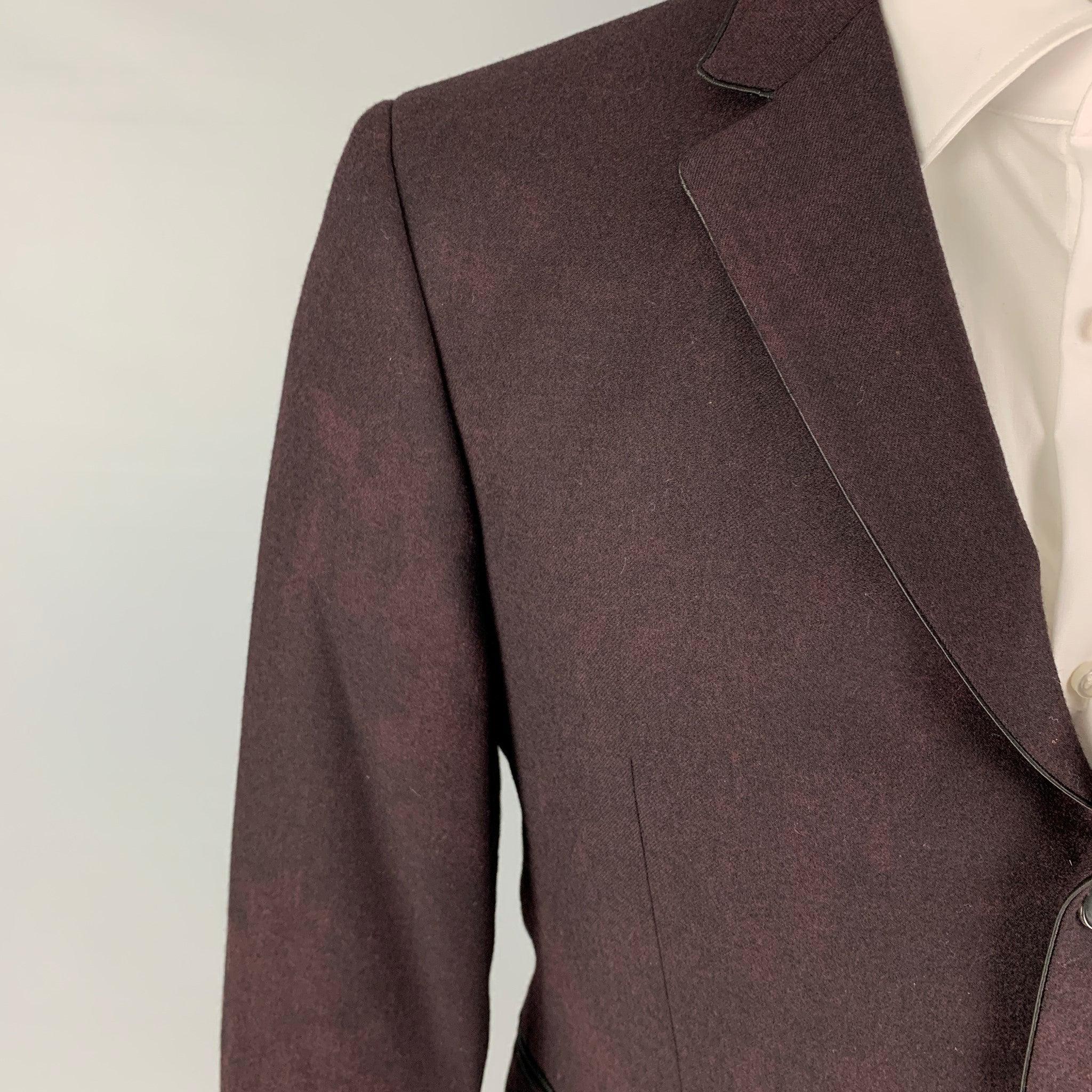 JOHN VARVATOS sport coat comes in a burgundy / black dyed wool with a full liner featuring a notch lapel, slit pockets, double back vent, and a three button closure. Made in Italy.
Very Good
Pre-Owned Condition. 

Marked:   48 

Measurements: 
