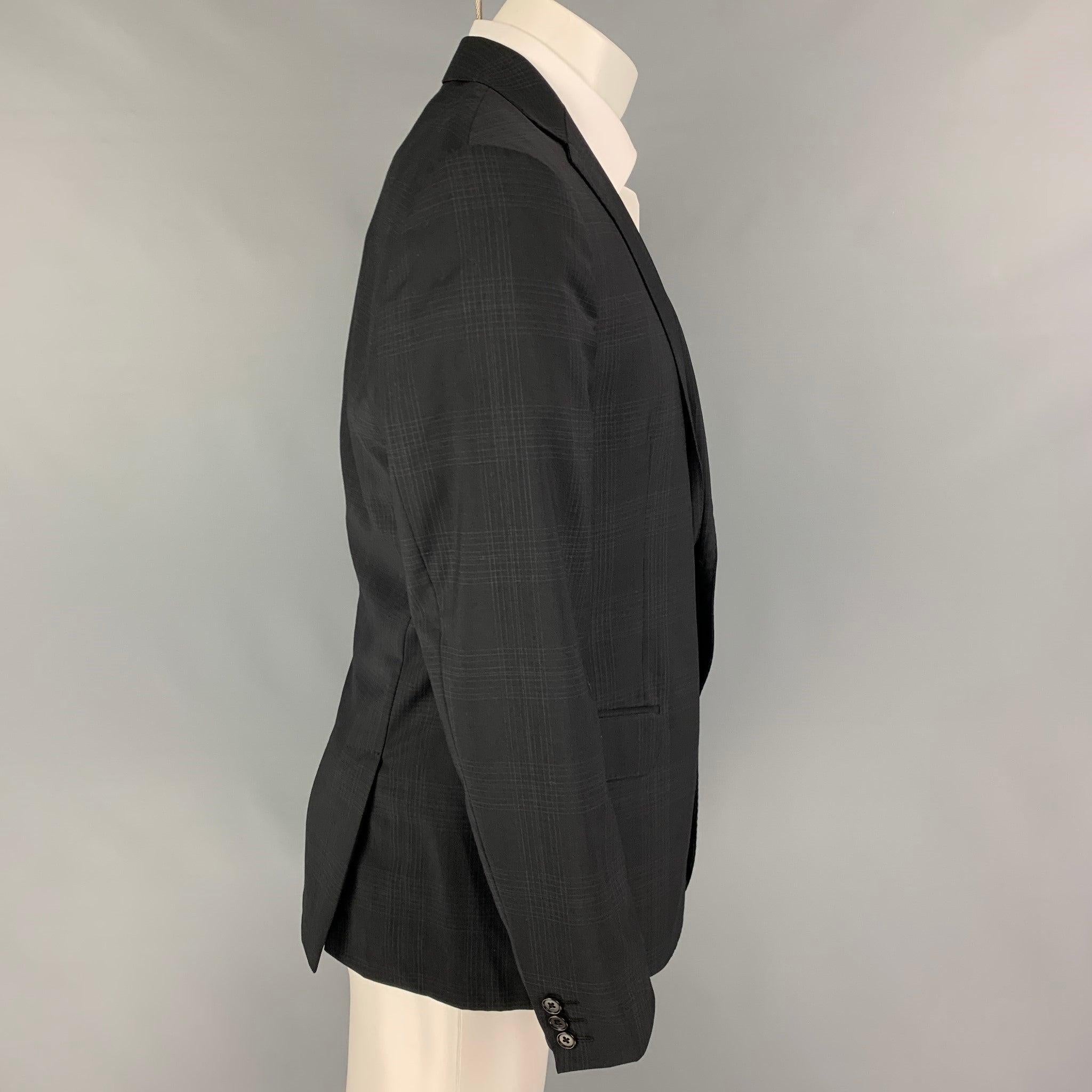 JOHN VARVATOS sport coat comes in a black plaid wool with a full liner featuring a notch lapel, flap pockets, double back vent, and a double button closure. Made in Italy.
Very Good
Pre-Owned Condition. 

Marked:   50 

Measurements: 
 
Shoulder: