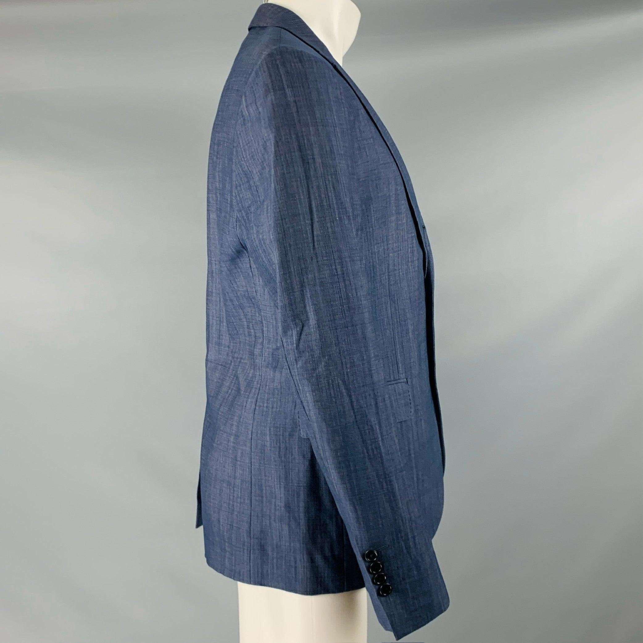 JOHN VARVATOS sport coat
in a blue
grey virgin wool blend fabric featuring notch lapel, single vented back, and three button closure. Made in Italy.Very Good Pre-Owned Condition. Minor signs of wear, missing top button. 

Marked:   50