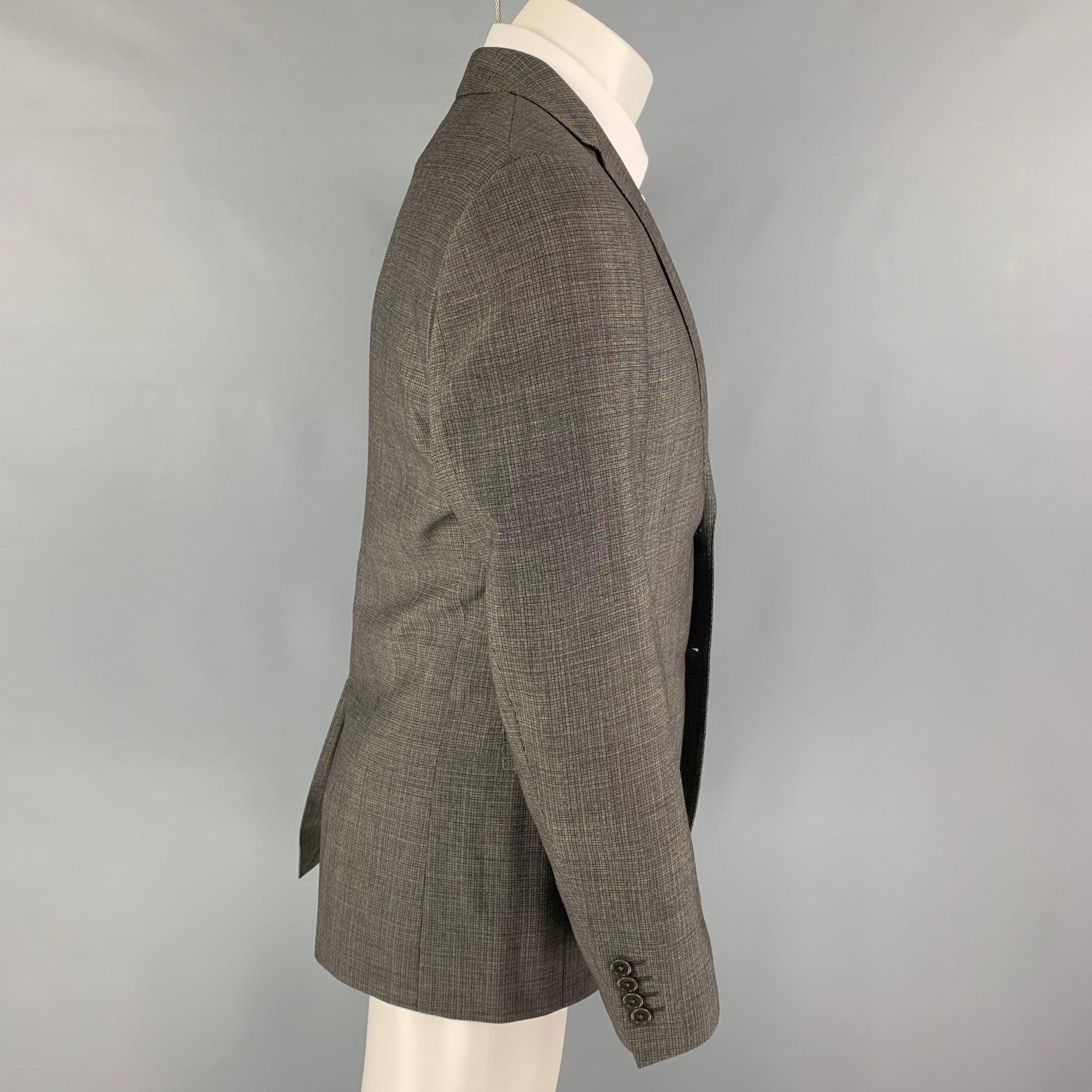 JOHN VARVATOS
sport coat comes in a grey & black wool with a full liner featuring a notch lapel, flap pockets, single back vent, and a double button closure. Excellent
Pre-Owned Condition. 

Marked:   Size tag removed 

Measurements: 
 
Shoulder: