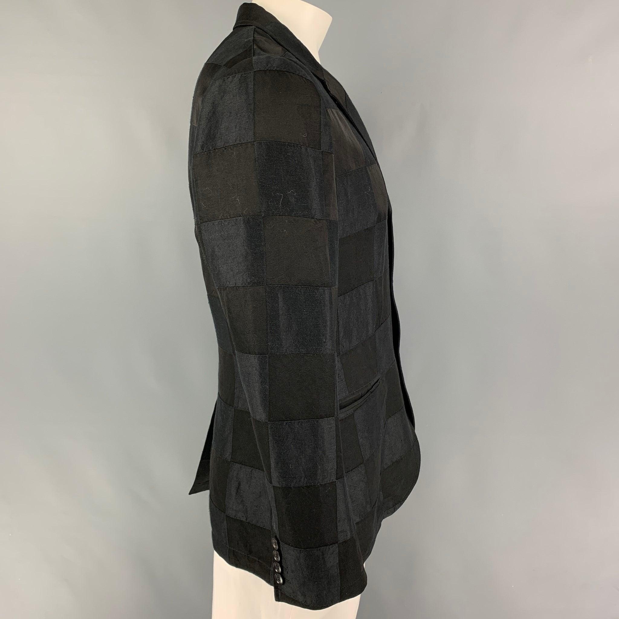 JOHN VARVATOS sport coat comes in a black & charcoal checkered material featuring a notch lapel, slit pockets, single back vent, and a three button closure. Made in Italy.
Very Good
Pre-Owned Condition.
Fabric tag removed.  

Marked:   52