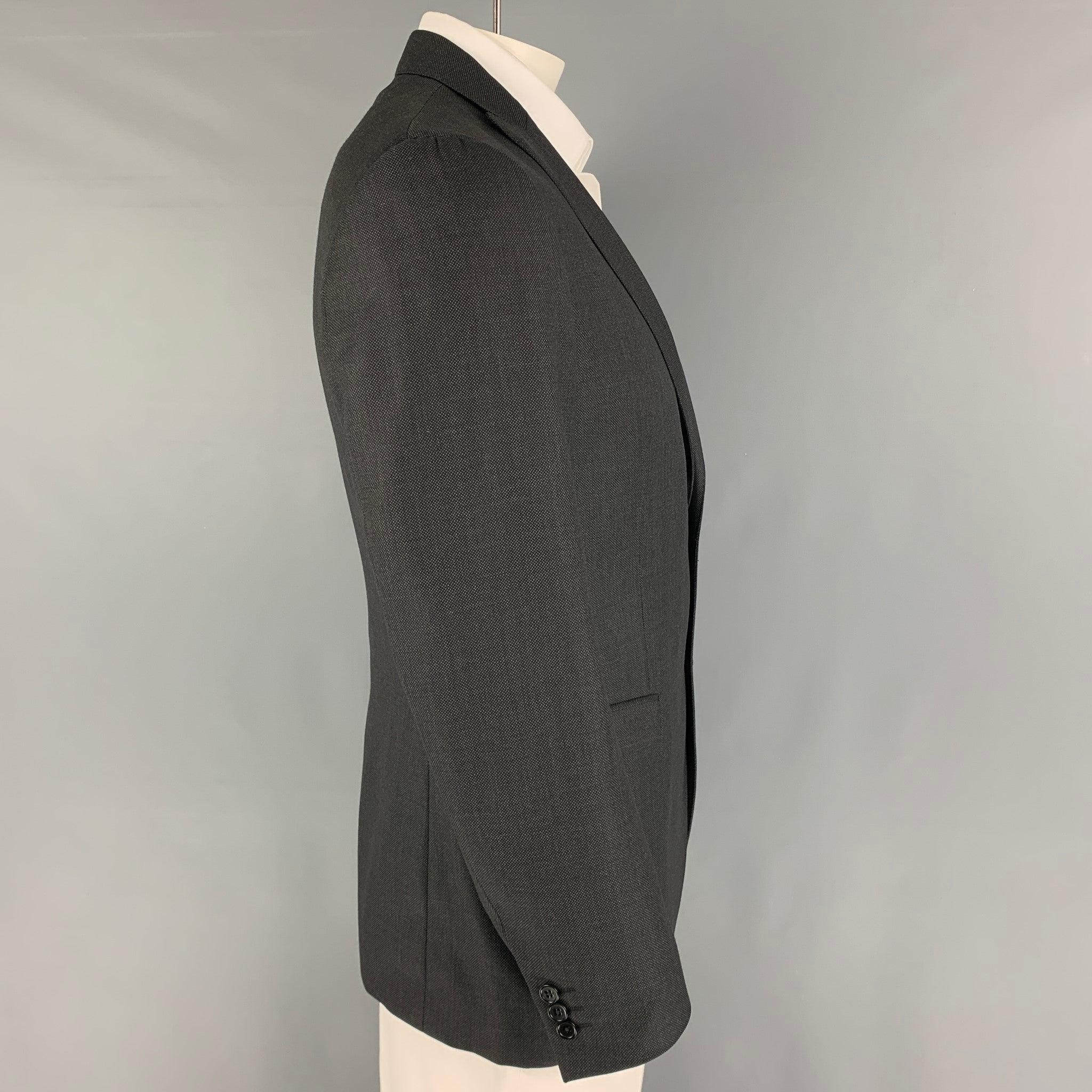 JOHN VARVATOS sport coat comes in a charcoal wool with a full liner featuring a peak lapel, flap pockets, single back vent, and a double button closure. Made in Italy.
Excellent
Pre-Owned Condition. 

Marked:   52 R  

Measurements: 
 
Shoulder: