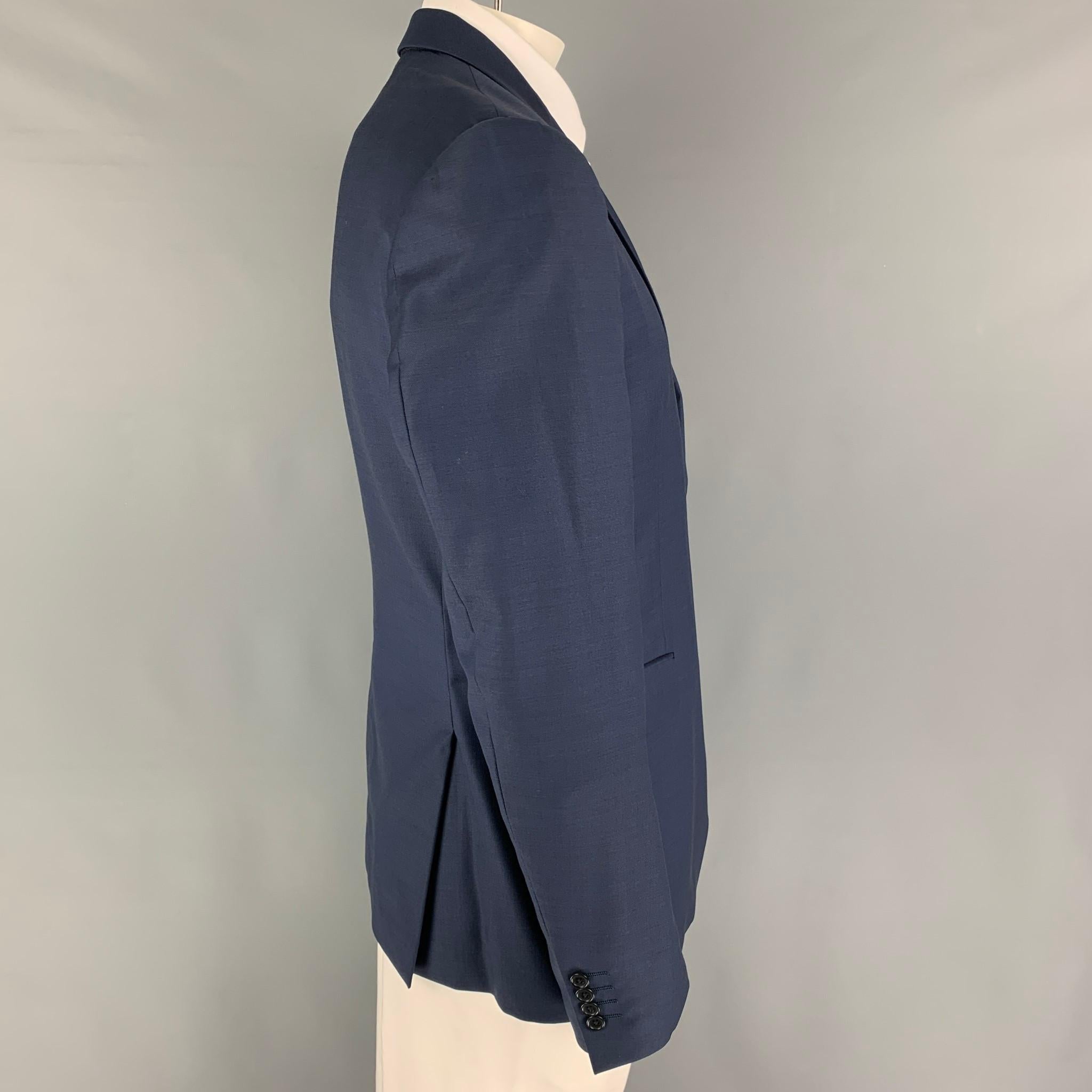JOHN VARVATOS sport coat comes in a blue wool with a full liner featuring a notch lapel, flap pockets, double back vent, and a double button closure. Made in Italy. 

Excellent Pre-Owned Condition. Light wear at underarm. As-is.
Marked: 54
