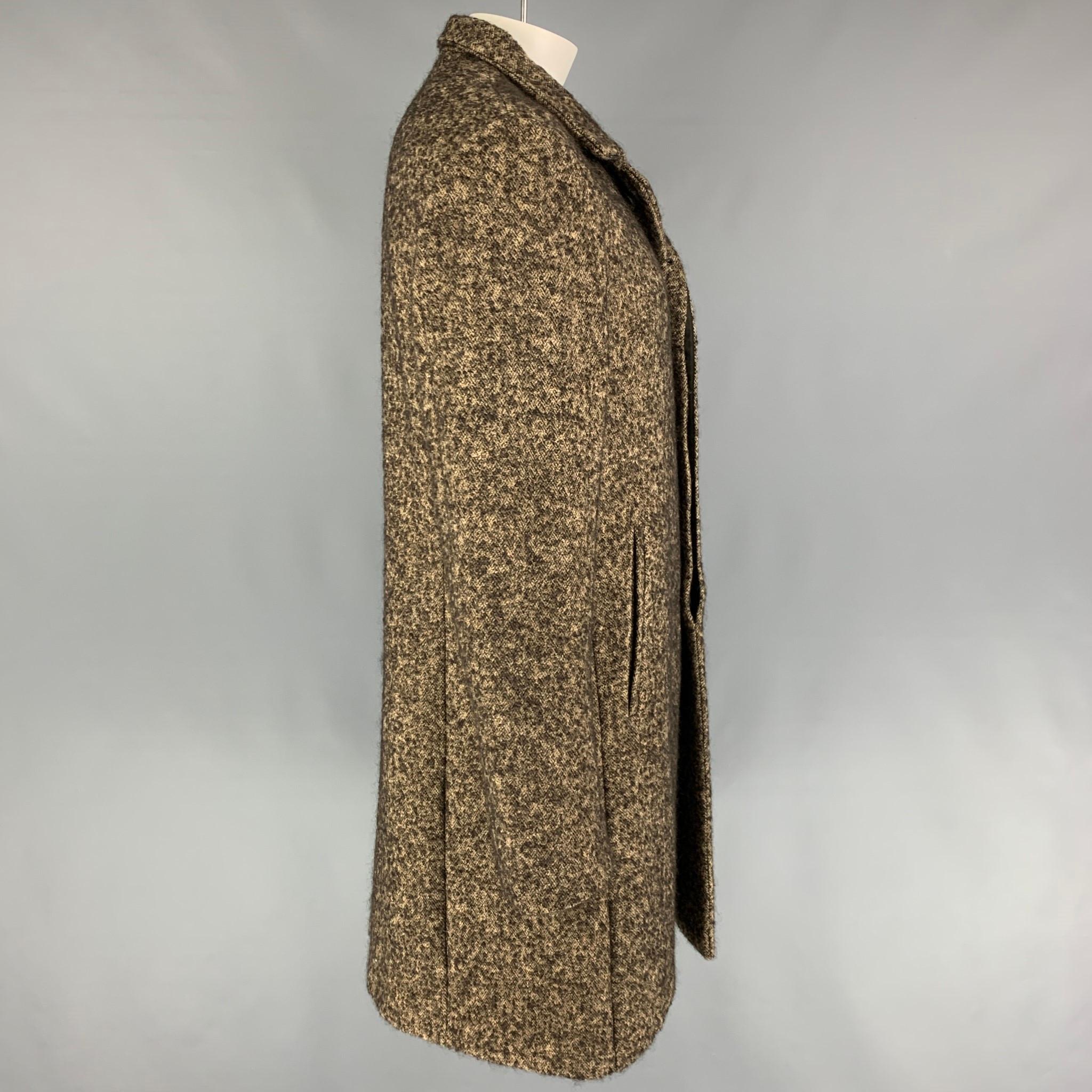 JOHN VARVATOS coat comes in a ta & brown heather wool blend featuring a spread collar, slit pockets, single back vent, and a hidden placket closure. Made in Italy. 

Very Good Pre-Owned Condition.
Marked: 54

Measurements:

Shoulder: 20.5 in.
Chest: