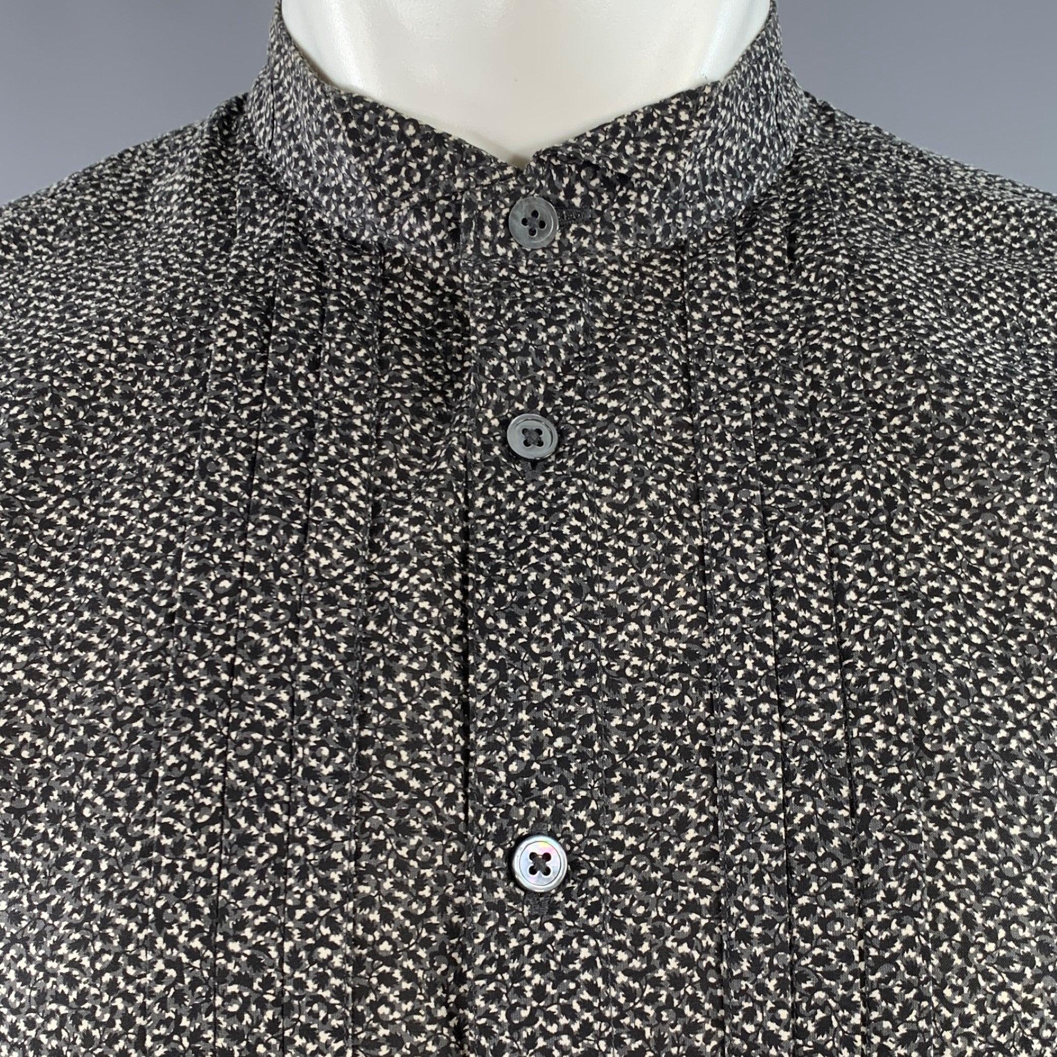 JOHN VARVATOS tuxedo long sleeve shirt
in a black and white cotton blend fabric featuring an abstract floral pattern, wingtip collar, pleated design, French cuffs, and button closure. Cufflinks not included.Excellent Pre-Owned Condition.  

Marked: 