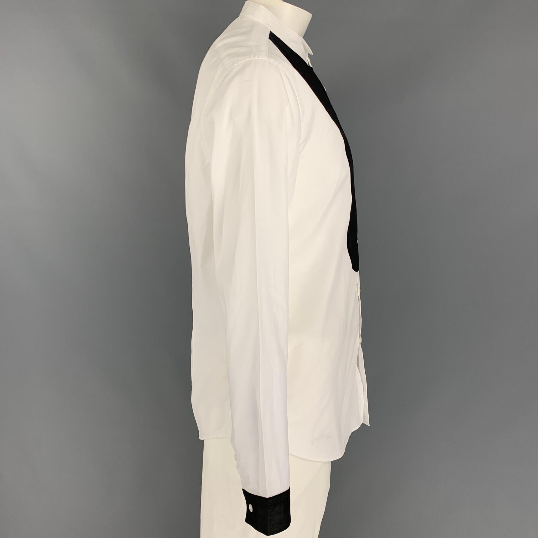 JOHN VARVATOS tuxedo long sleeve shirt comes in a white cotton featuring a black panel detail, stand up collar, and a buttoned closure. Made in Italy. 

Very Good Pre-Owned Condition.
Marked: XL

Measurements:

Shoulder: 19.5 in.
Chest: 44