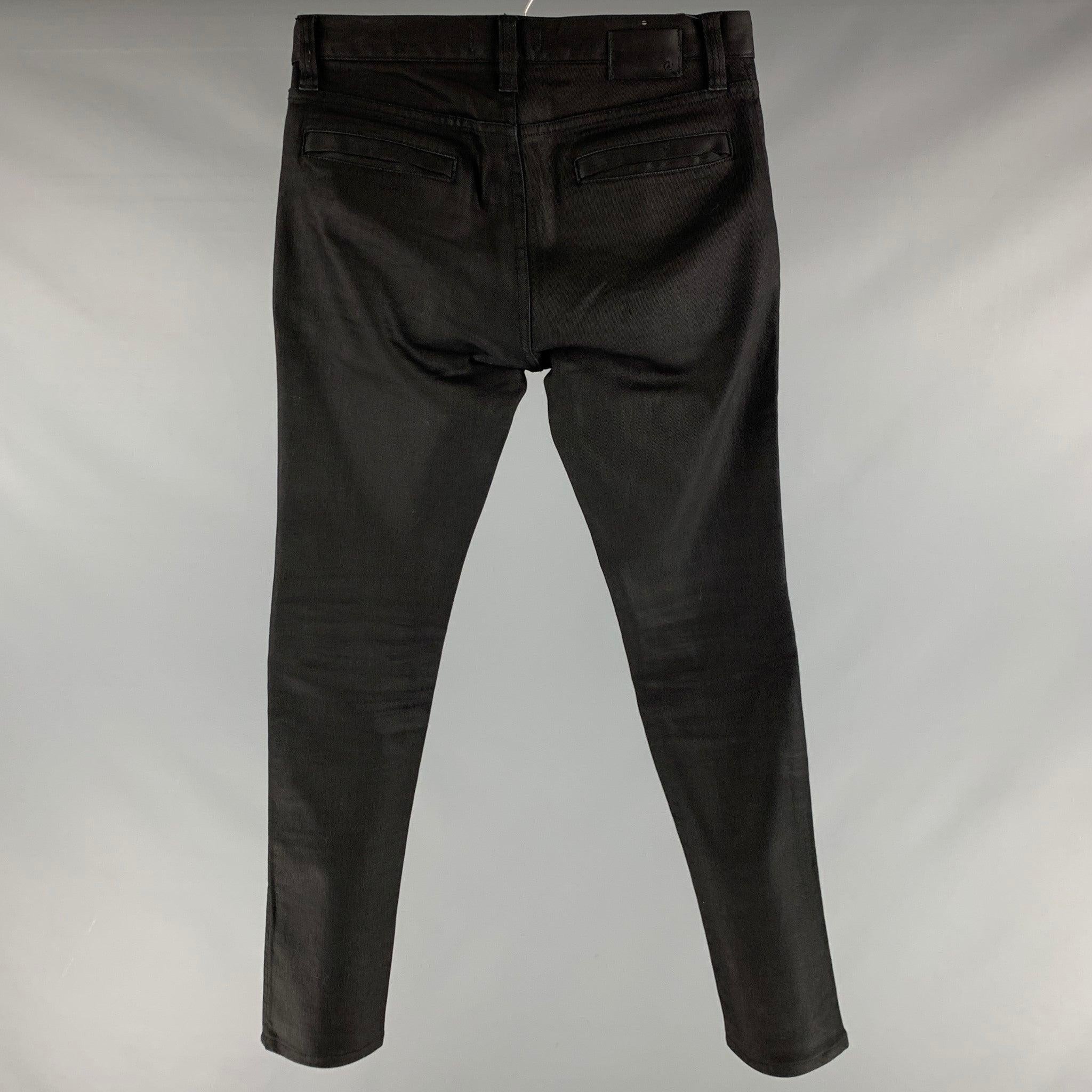 JOHN VARVATOS * U.S.A. jeans
in a black cotton blend fabric featuring two pockets with zippers, knee details, and zip fly closure.Very Good Pre-Owned Condition. Minor signs of wear. 

Marked:   30 

Measurements: 
  Waist: 30 inches Rise: 8 inches