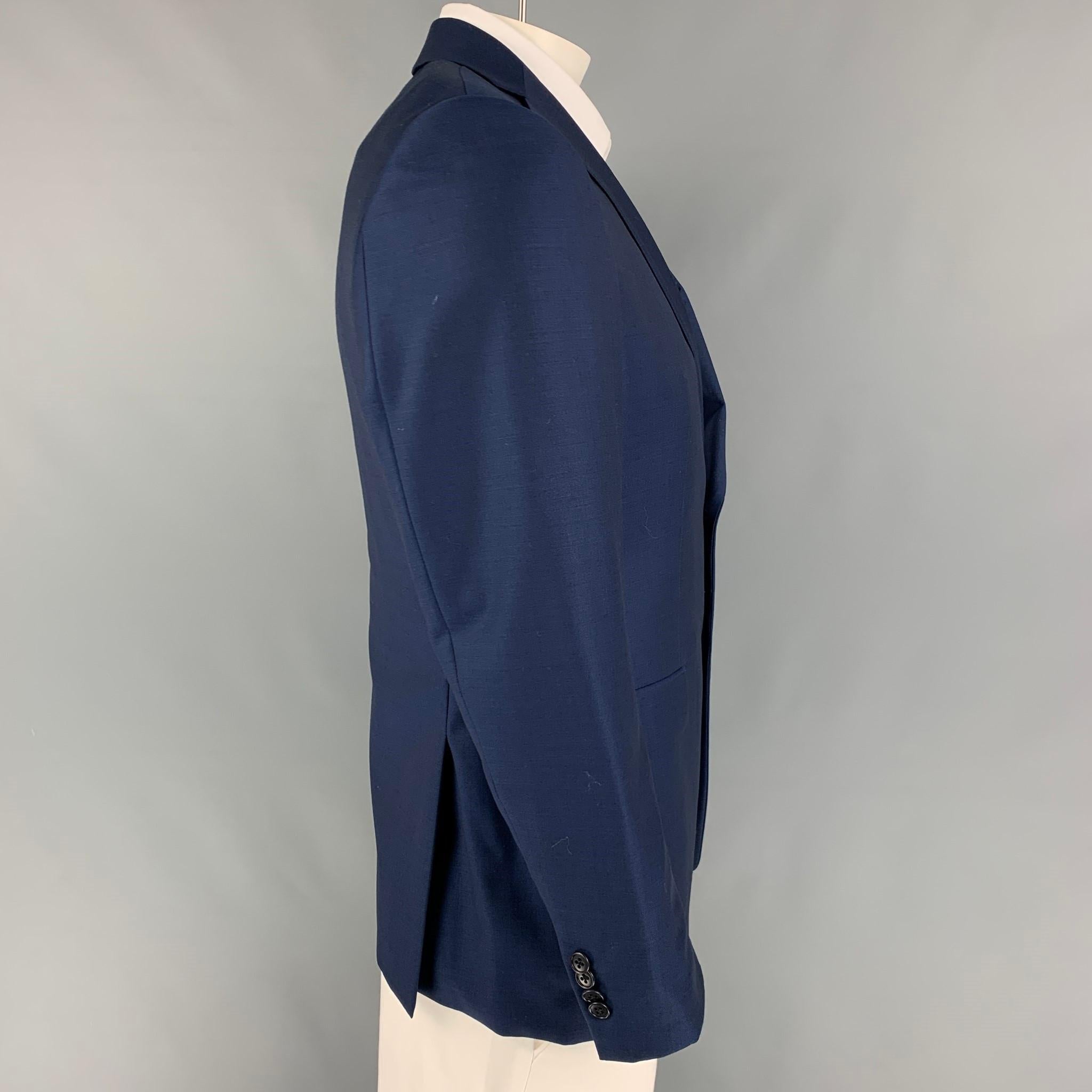 JOHN VARVATOS *U.S.A sport coat coms in a navy wool with a full liner featuring a notch lapel, flap pockets, double back vent, and a double button closure. 

Very Good Pre-Owned Condition.
Marked: 40 R

Measurements:

Shoulder: 18 in.
Chest: 40