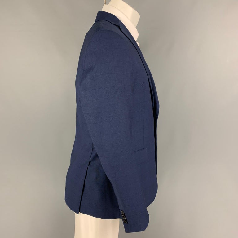JOHN VARVATOS *U.S.A. sport coat comes in a navy window pane wool fabric by Loro Piana with a full liner featuring a notch lapel, flap pockets, double back vent, and a double button closure. 

Very Good Pre-Owned Condition.
Marked: 40