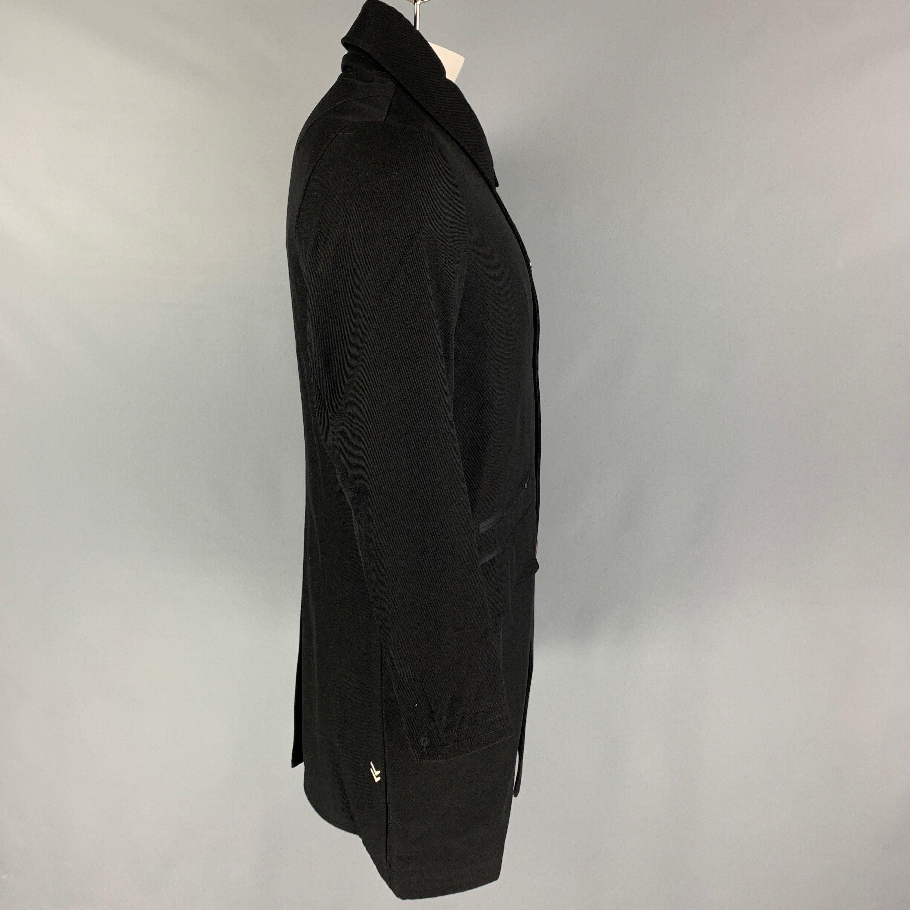 JOHN VARVATOS x CONVERSE coat comes in a black lana wool slap pockets, single back vent, ribbed collar, spread collar, and a buttoned closure.
Excellent
Pre-Owned Condition.  

Marked:   Size tag removed.  

Measurements: 
 
Shoulder: 17.5 inches