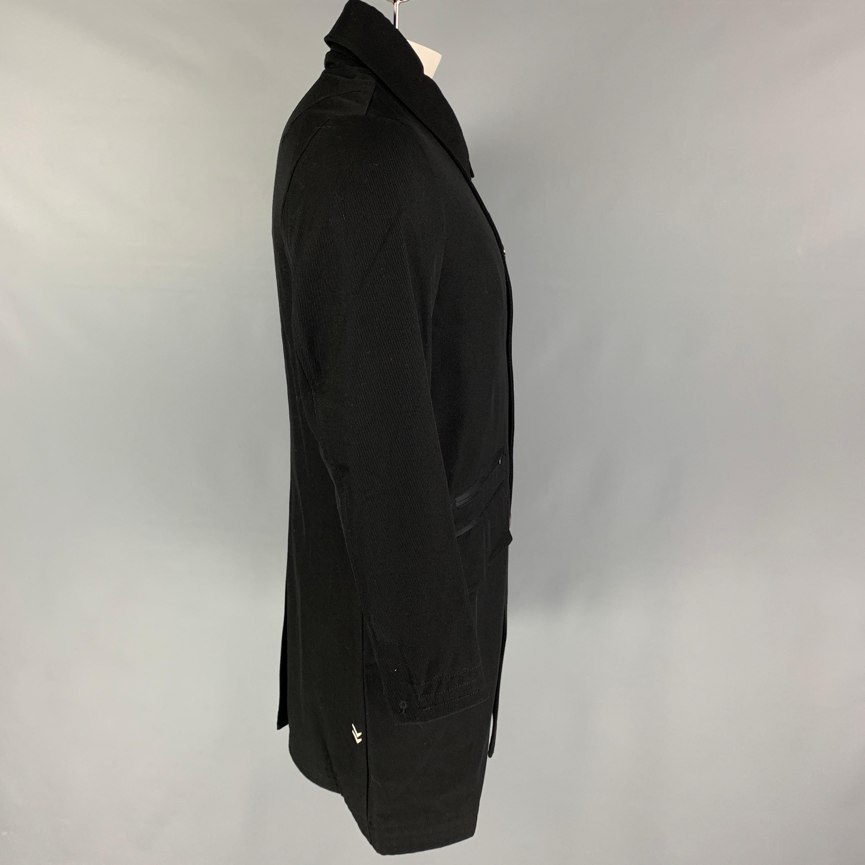 JOHN VARVATOS x CONVERSE coat comes in a black lana wool slap pockets, single back vent, ribbed collar, spread collar, and a buttoned closure. 

Excellent Pre-Owned Condition.
Marked: Size tag removed.

Measurements:

Shoulder: 17.5 in.
Chest: 42