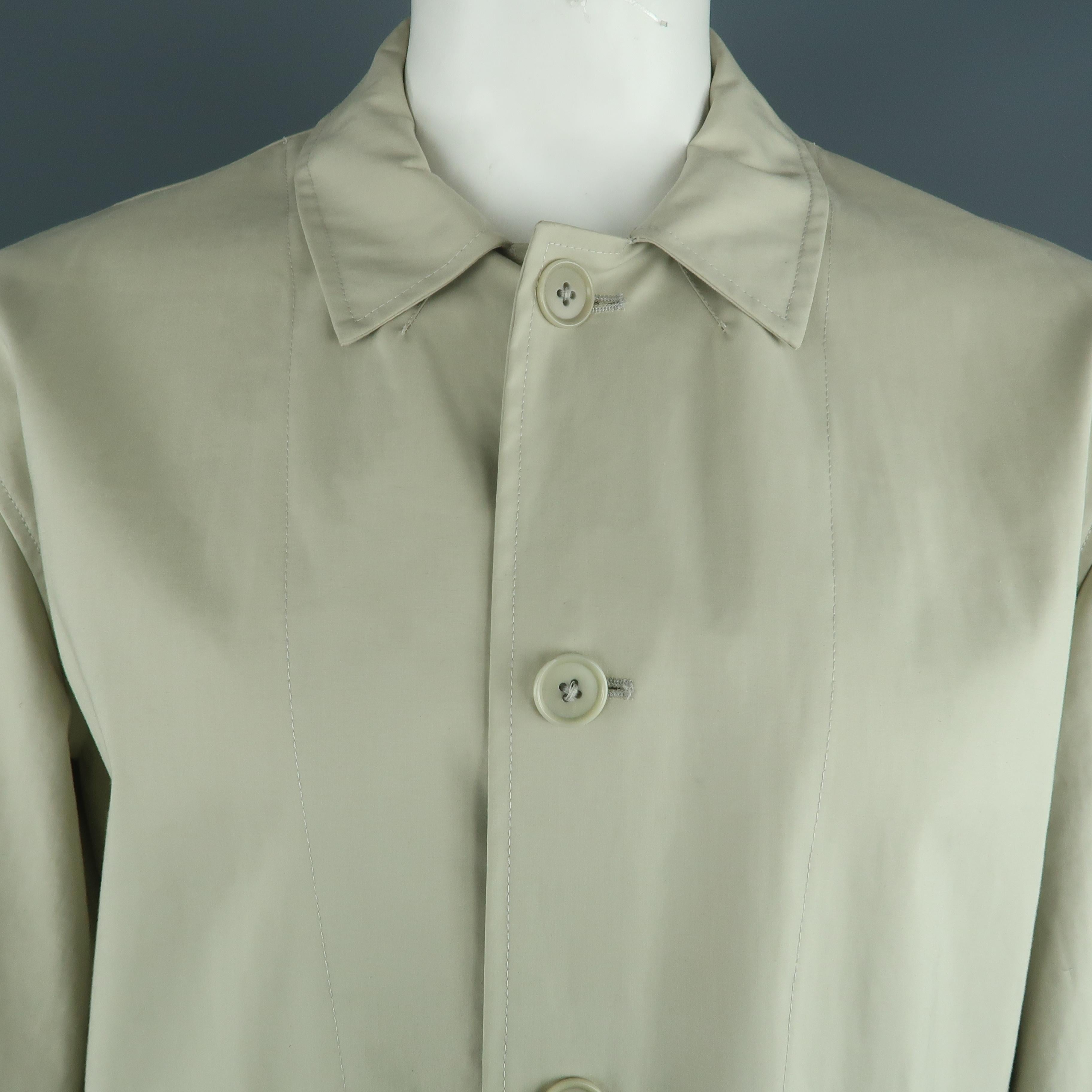 OHN VARVATOS coat comes in a khaki cotton featuring a belted style and flap pockets. Made in Italy.
 
Very Good Pre-Owned Condition.
Marked: XL
 
Measurements:
 
Shoulder: 20.5 in.
Chest: 48 in.
Sleeve: 25 in.
Length: 30 in.